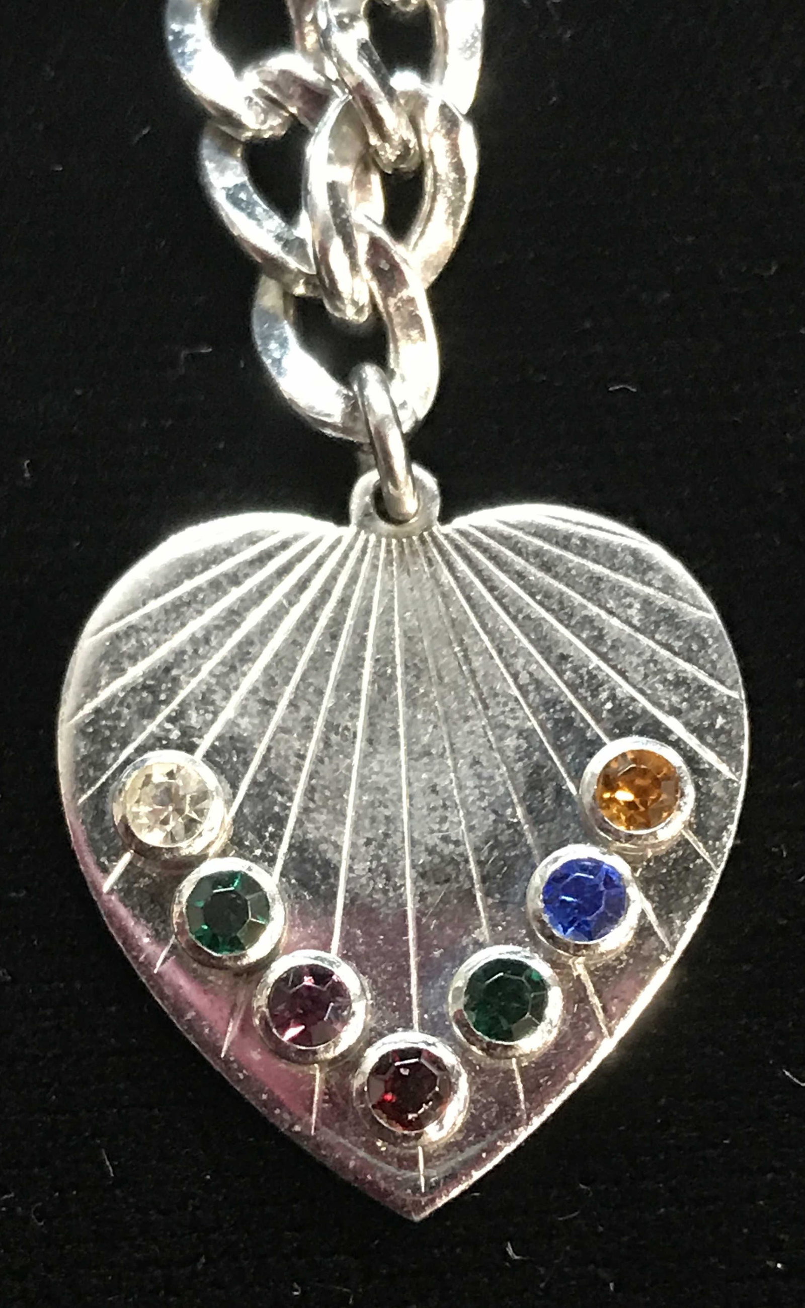 Sterling Heart Charm Chain Bracelet, 9.1 dwt: Sterling Silver Heart Charm, reads Sterling on verso, with multicolored crystals and etched Art Deco lines. Curd chain with box clasp, reads Sterling on clasp. 6.5 in.Long. 9.1 dwt is with crystals. P
