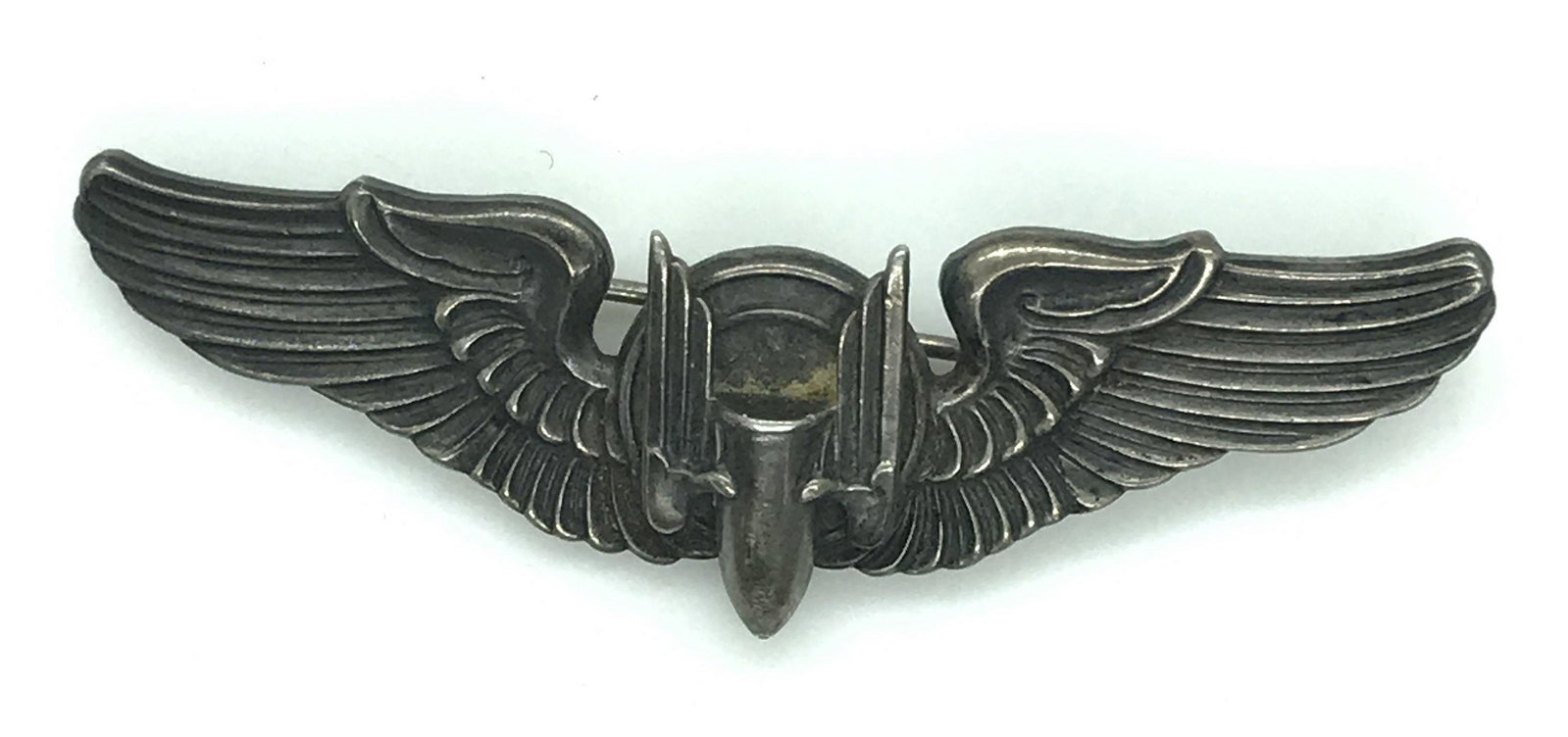 Vintage Sterling Silver ‘Wing’ Brooch, 14.6 dwt: 3 in. long embossed wing pin, center shield motif, verso reads Sterling and has an impressed Shield hallmark, appears to read ‘ Meyer’ and appears to begin with the # 9 (for sterling purity). Prop