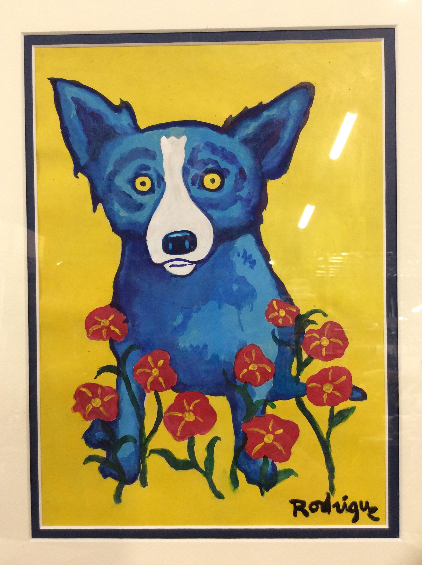 Signed Gouache on Paper AFTER George Rodrigue: Signed Gouache on paper, subject blue dog with red poppy flowers, primary color palette, blue and white linen matting, Gilt wood frame, signed in paint lower right corner Rodrigue, frame in good condi