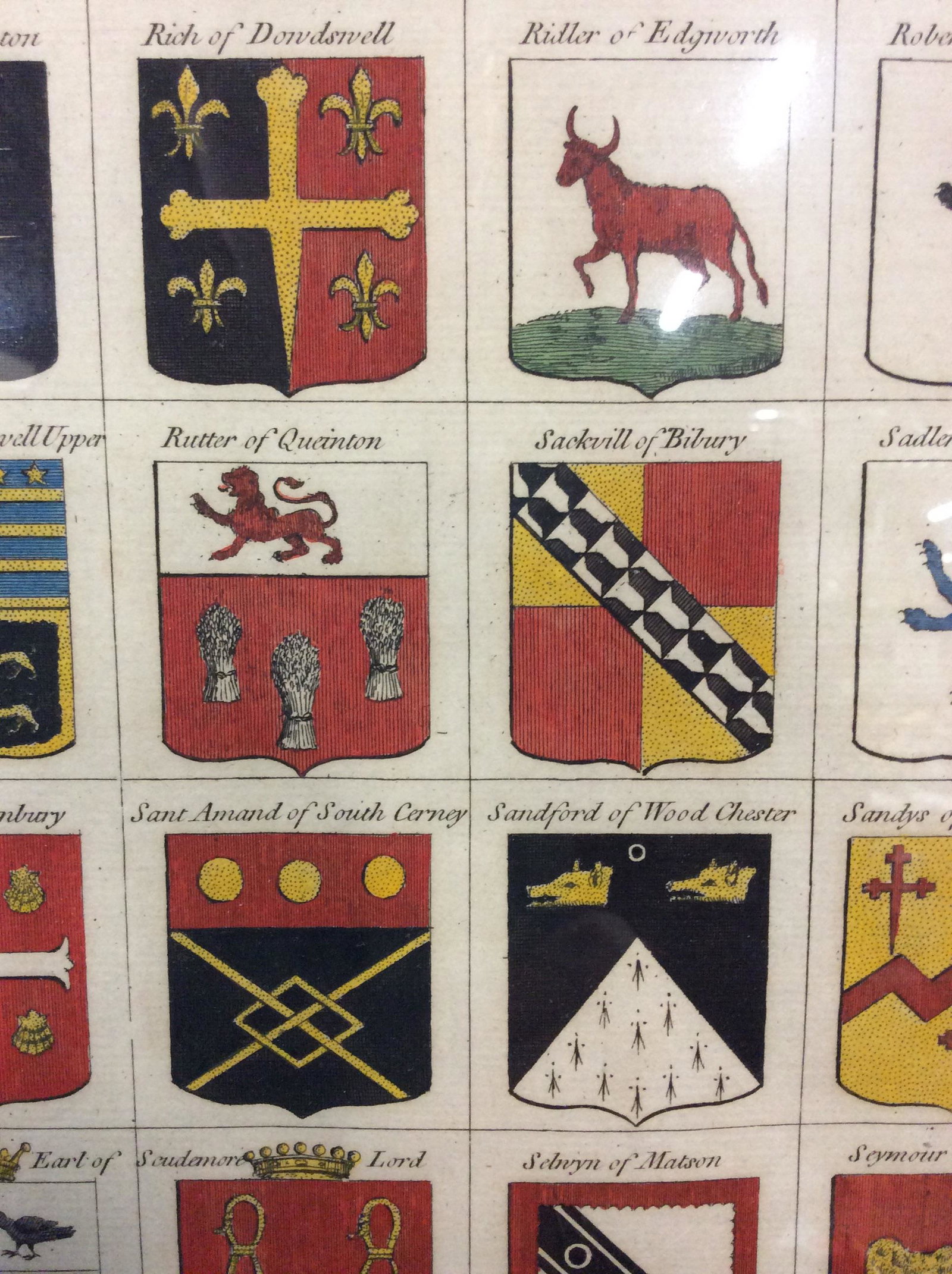 Pair of Antique Engraving Prints Of Family Crests: Pair of Antique Engraving Prints Of Heraldic Armorial English Family Crests, possibly hand colored, 19th Century, Blue Linen matting, Carved Gilt Wooden Frames, both Frames in good condition, no appar