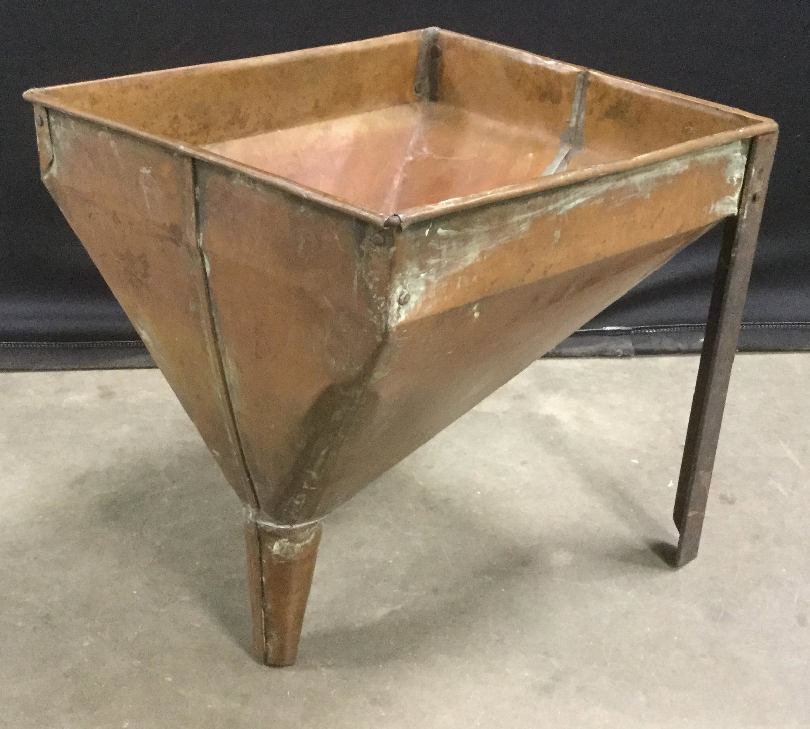 Antique Copper Footed Strainer: This is an antique copper strainer. The piece is a funnel supported by two legs, a perforated sheet of metal has been welded to the inside of the funnel. The piece measures approx 15 inches H, 14 inch