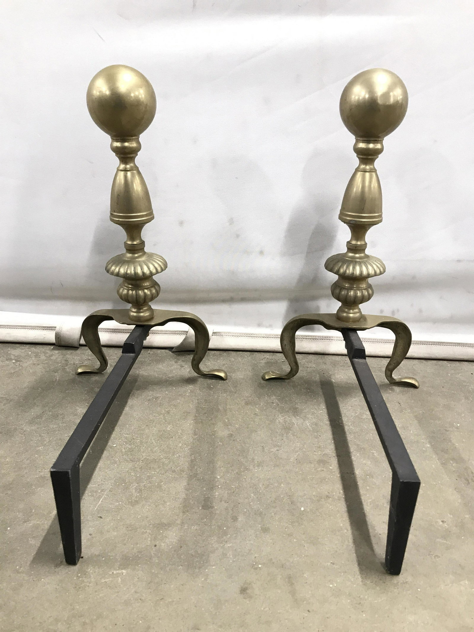 Pair Vintage Brass Andirons: Andirons are gold toned and brass. Each have spherical structure on top. Andirons, Brass Andirons, Vintage Andirons, Vintage Brass Andirons. Each piece measures approximately 12 inches long 8 inches w