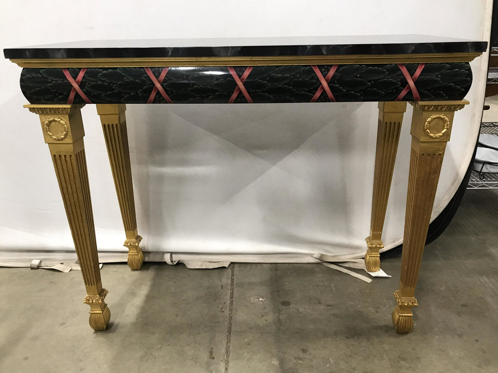 Hand Painted French Vintage Wooden Console Table: Console table appears to be wooden. Piece is handpainted & French. Tabletop mimics marble appearance. Underneath tabletop has grape & leaf detail. Table legs appear to be gold leafed. Measures approxi
