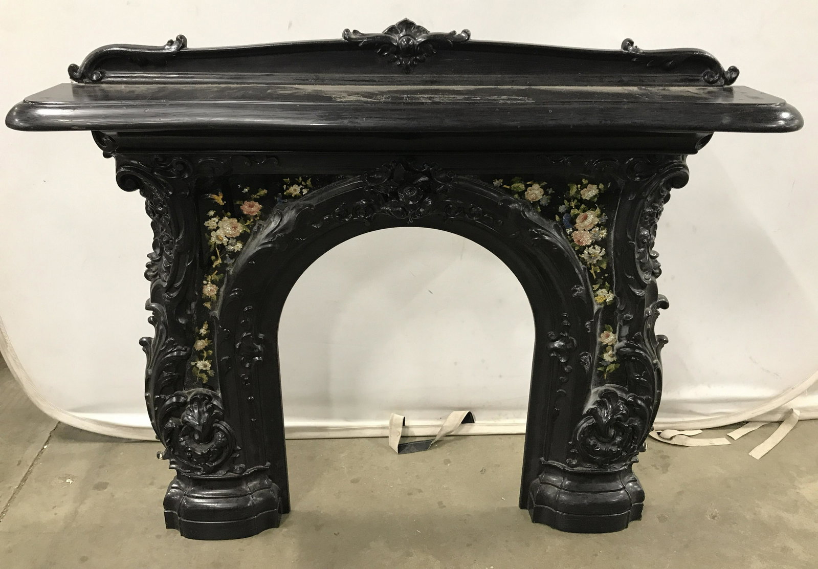 HIRIAM TUCKER Iron Fireplace Mantel W Eglomise: Hiram Tucker Boston MA Cast Iron Fireplace Mantel with Églomisé. Measures approximately 48 inches long 42 inches tall 9 inches deep. Cast iron fireplace serpentine form mantel and surround, circa 18