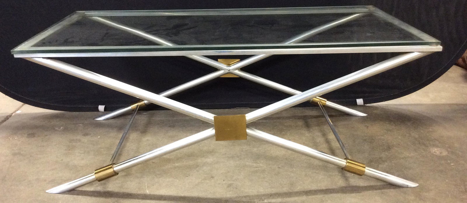 Vintage Art Deco Style Glass & Chrome Coffee Table: Vintage Art Deco Style Glass Topped and Chrome Coffee Table with X base and gold toned metal accents, some surface scratches to glass top and base, measures approximately 44 inches long x 22 inches wi
