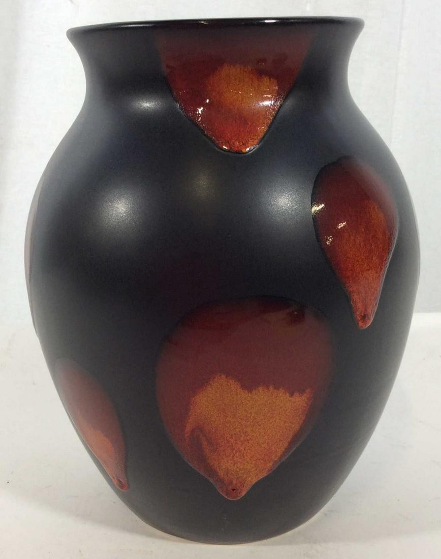 Poole English Pottery Vase: Black toned ceramic vase with drip glaze design in red and orange tones, with dimension over semi matte black. Marked on underside Poole with Dolphin, Pottery England, some minor surface wear, imperfe