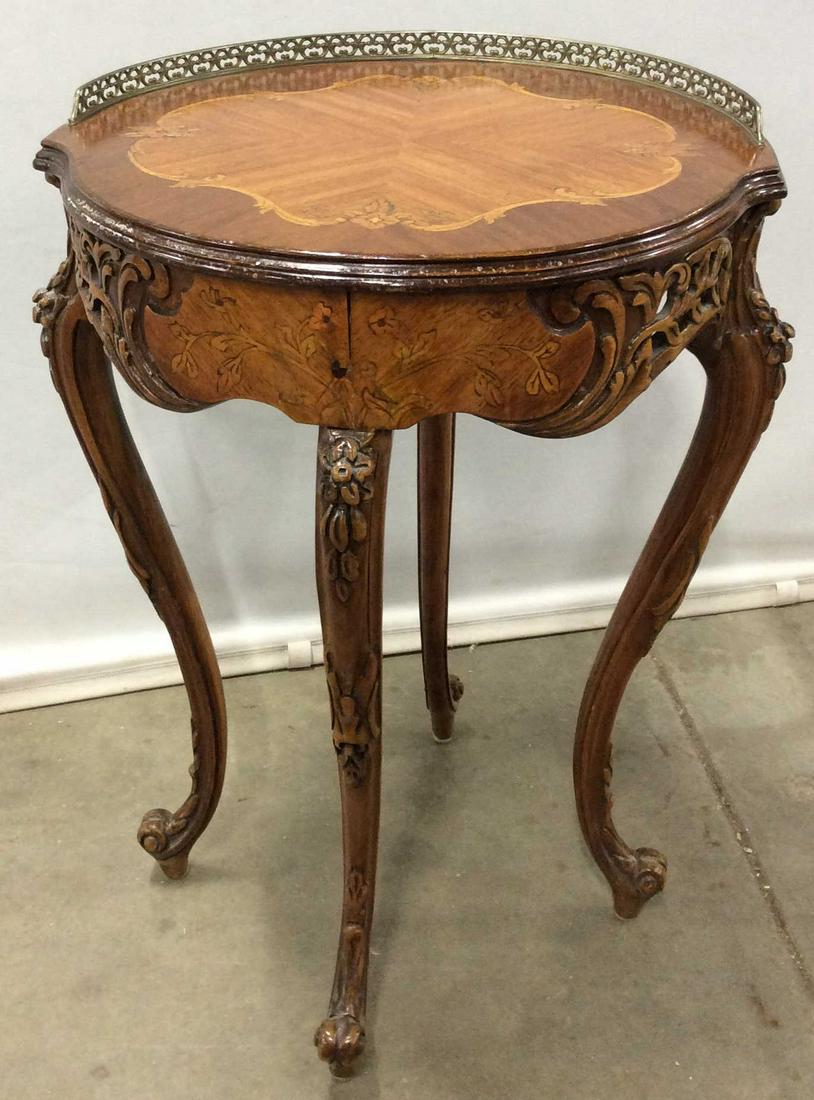 Vintage Carved Wood Side Table: This is a vintage, possibly antique, side table in the style of Louis XV. The surface of the table is decorated with a multi toned, floral patterned, wooden Inlay. The table is hand carved, and the le