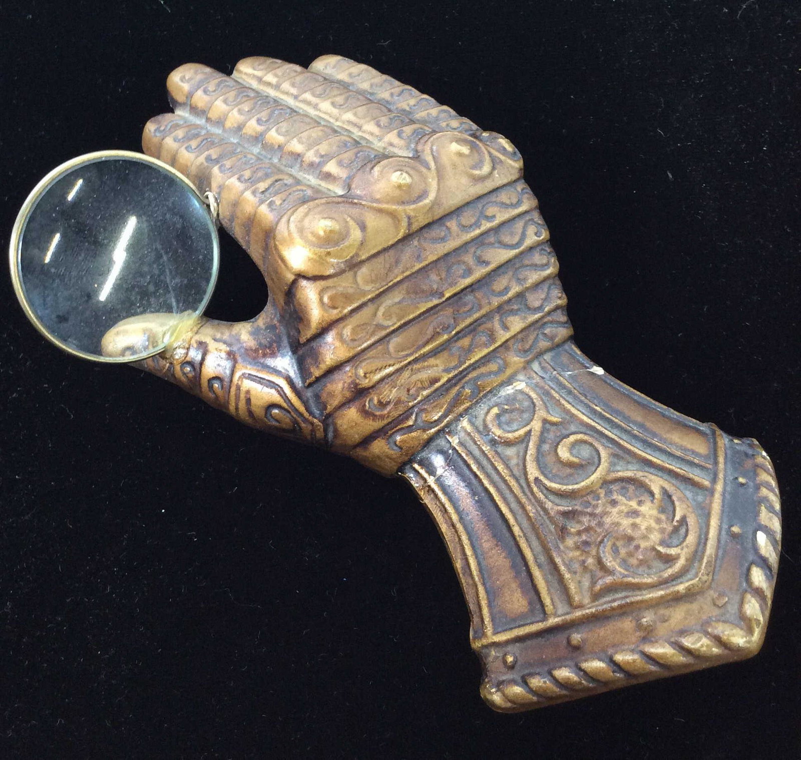 LEGO Ceramic hand Magnifying Glass: Paperweight / Magnifying Glass, ceramic Hand. Formed to resemble a hand in knights armor, with magnifying glass, evident repairs and cracks to piece, Marked LEGO on underside, measures approx 6 in by 