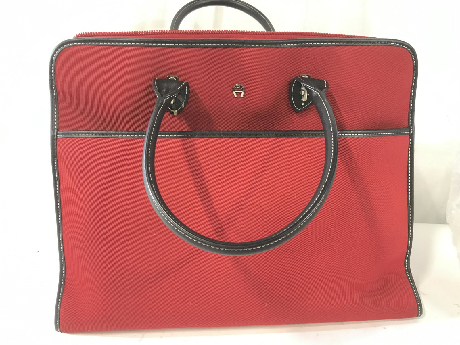 Etienne Aigner Large Canvas Red Tote: Large Red Fabric Tote Bag, large interior compartment with 2 wide & 2 small exterior pouch pockets. Black leather detail & hems. Sections for smaller items, main zipper closure. Measures 15.5 x 12.5 i