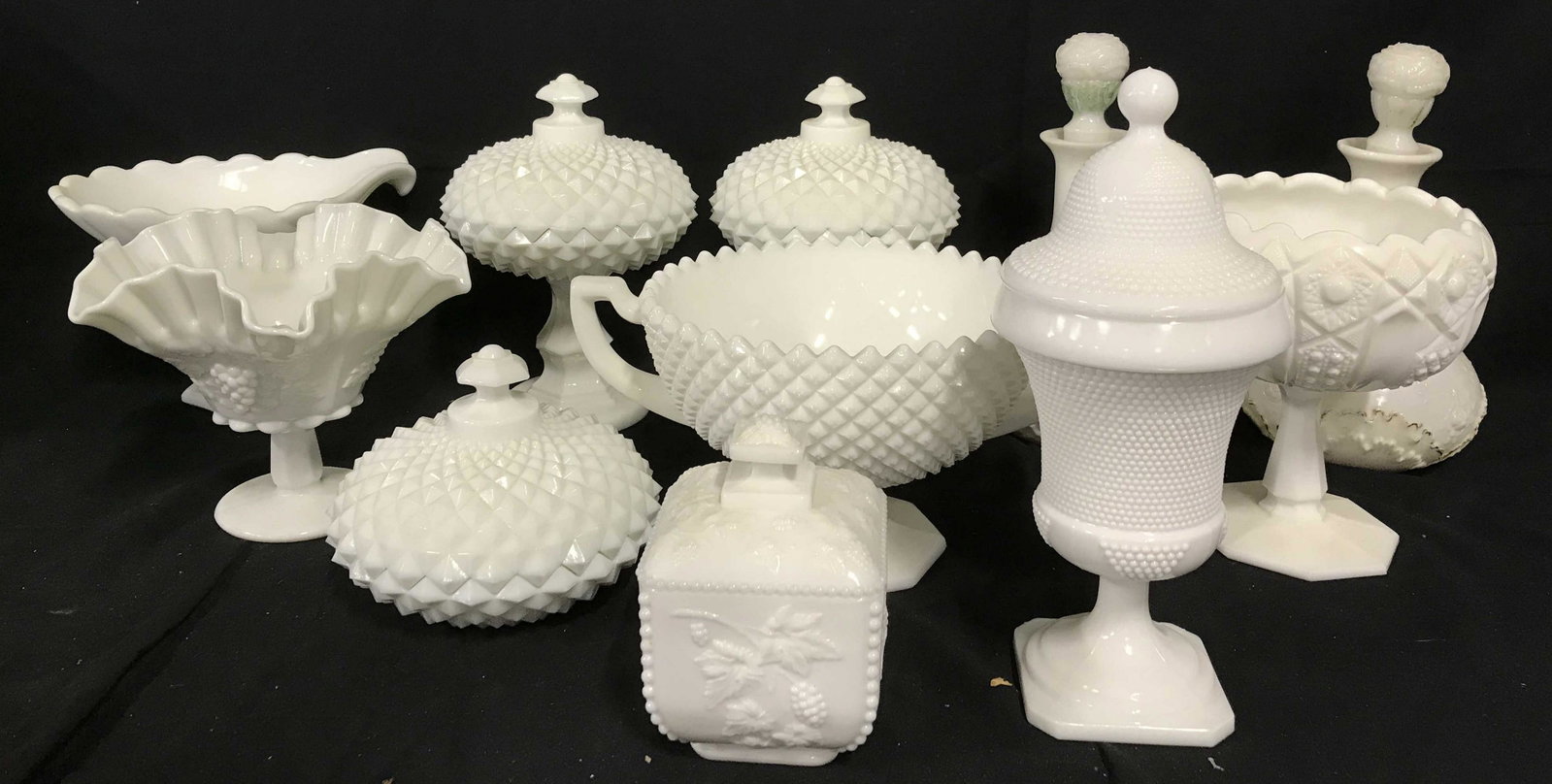 Set11 Milk Glass collectible dishware: Collectible milk glass tableware, candy dishes, decanters tazzas and more, varying stages of wear, primarily in good condition. One lidded box with relief blackberry branch design, measures approx 6 i