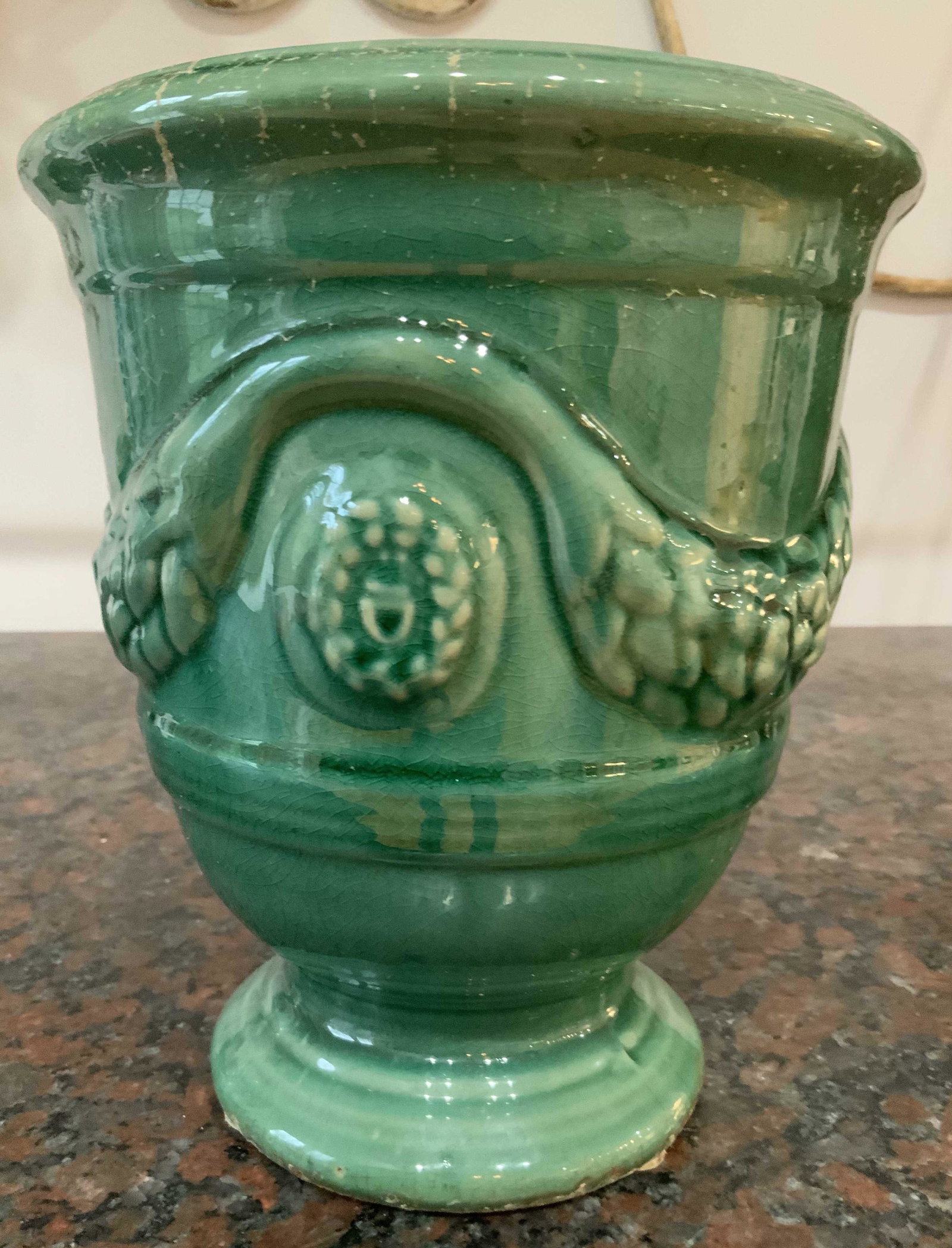 Green Majolica Style Pedestal Cache Pot: Footed cache pot, vase, vessel, table ware, short pedestal base green glazed ceramics pottery, with swag relief, measures ht 9 inches 7.5 inches diameter