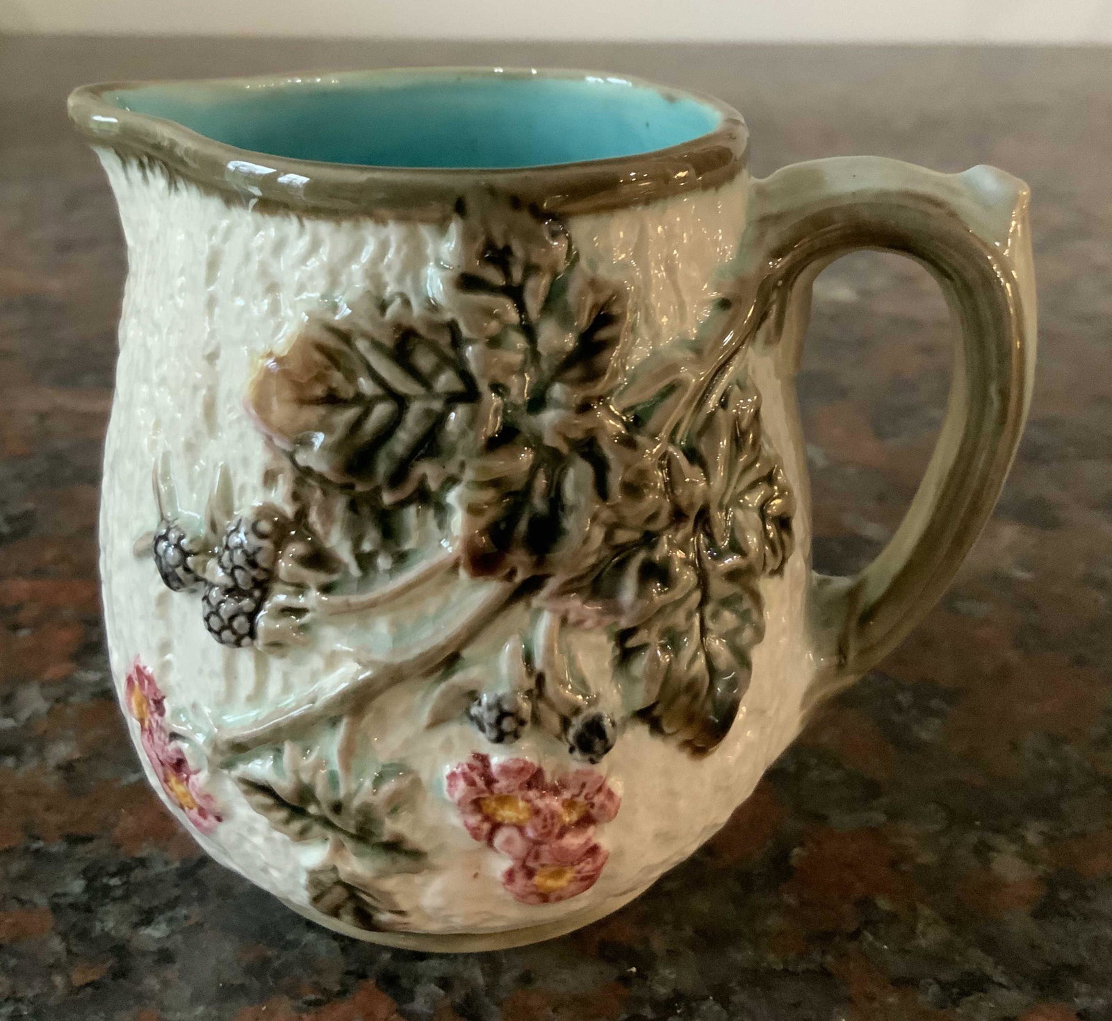 Antique Majolica Aqua glazed Pitcher: Vivid glazing on pottery, ceramics, collectible antique Majolica, pitcher vase vessel, tableware measures 5 by 5 inches, measures 4 by 4 inches, vine and floral relief deep aqua glazed interior, stamp