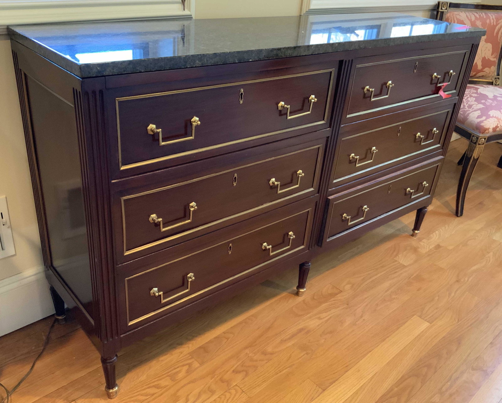 Mahogany and Brass Console table Marble Top: Double chest style console table with finish of dark highly polished mahogany, appears almost black as deep ebony wood, brass inset striping on front and sides, brass hardware on six drawers, classic 