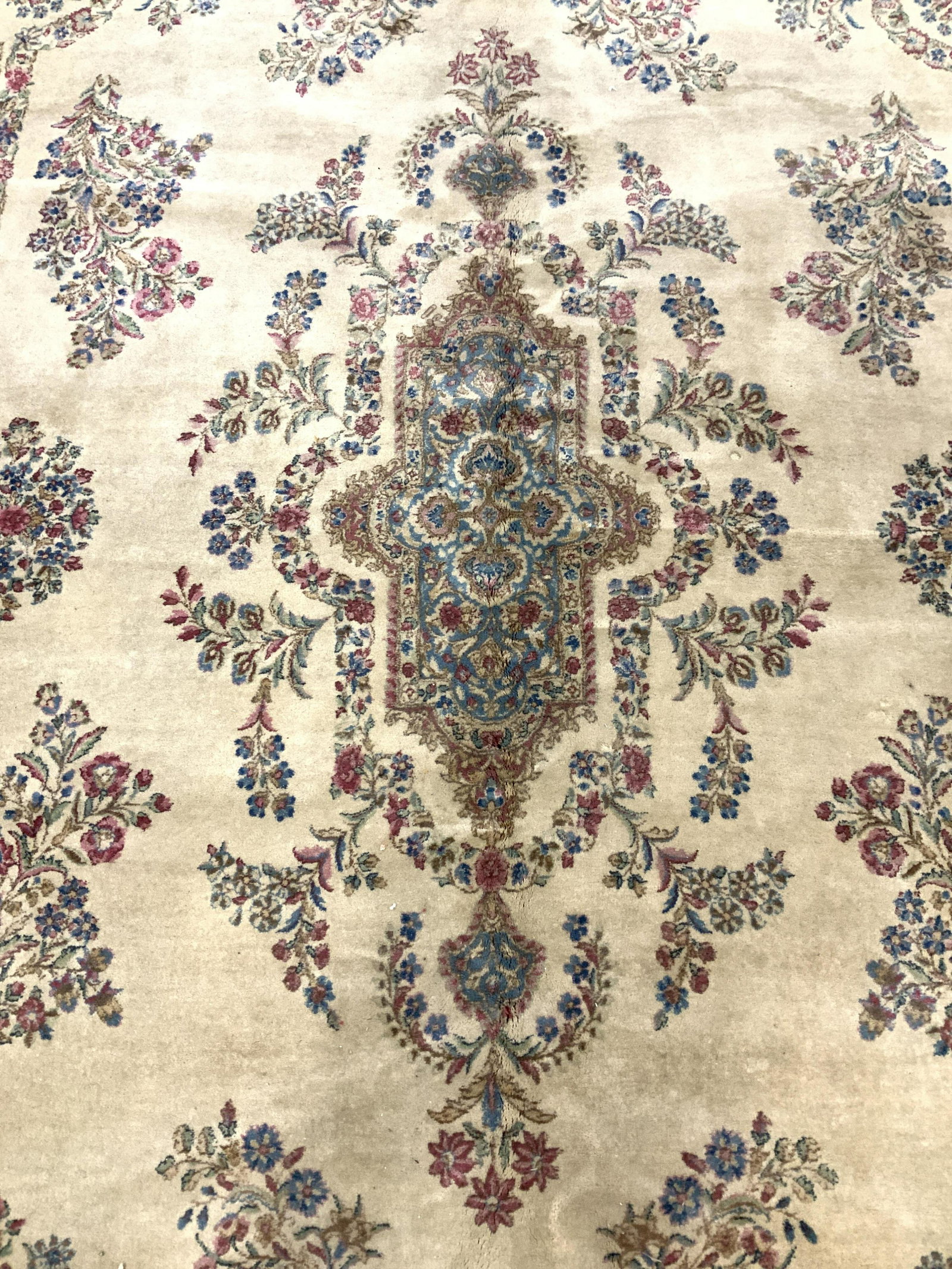 Vintage Handmade Oriental Oversized Wool Rug: Rug is wool & handmade. Piece has fringes. Rug appears to be antique. Rug contains multi toned floral, leaf, & geometric detail including tones of crew, black, red, yellow, sea foam, blue, sand pink, 