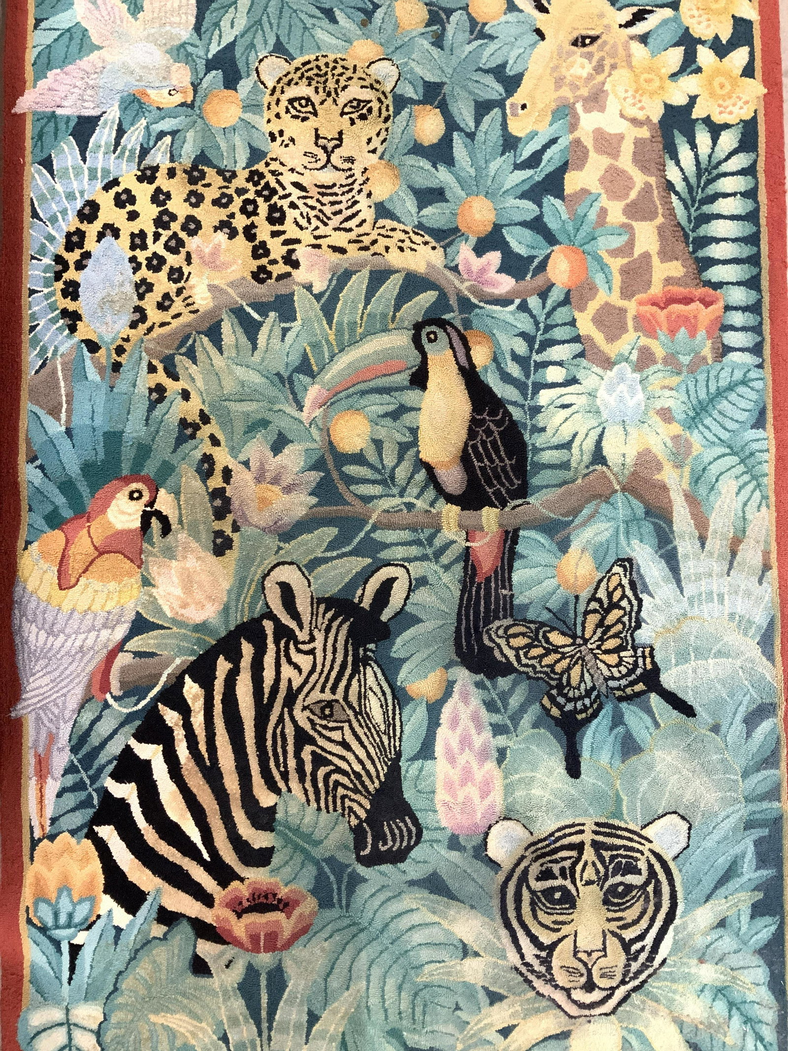 Vintage Jungle Animal Rug: Rug appears to be wool and handmade. Piece has needlepoint structure. Piece depicts multiple animals in a jungle setting. Piece measures approx 69 inches long 45 inches wide. Rug, wool rug, carpet, ar