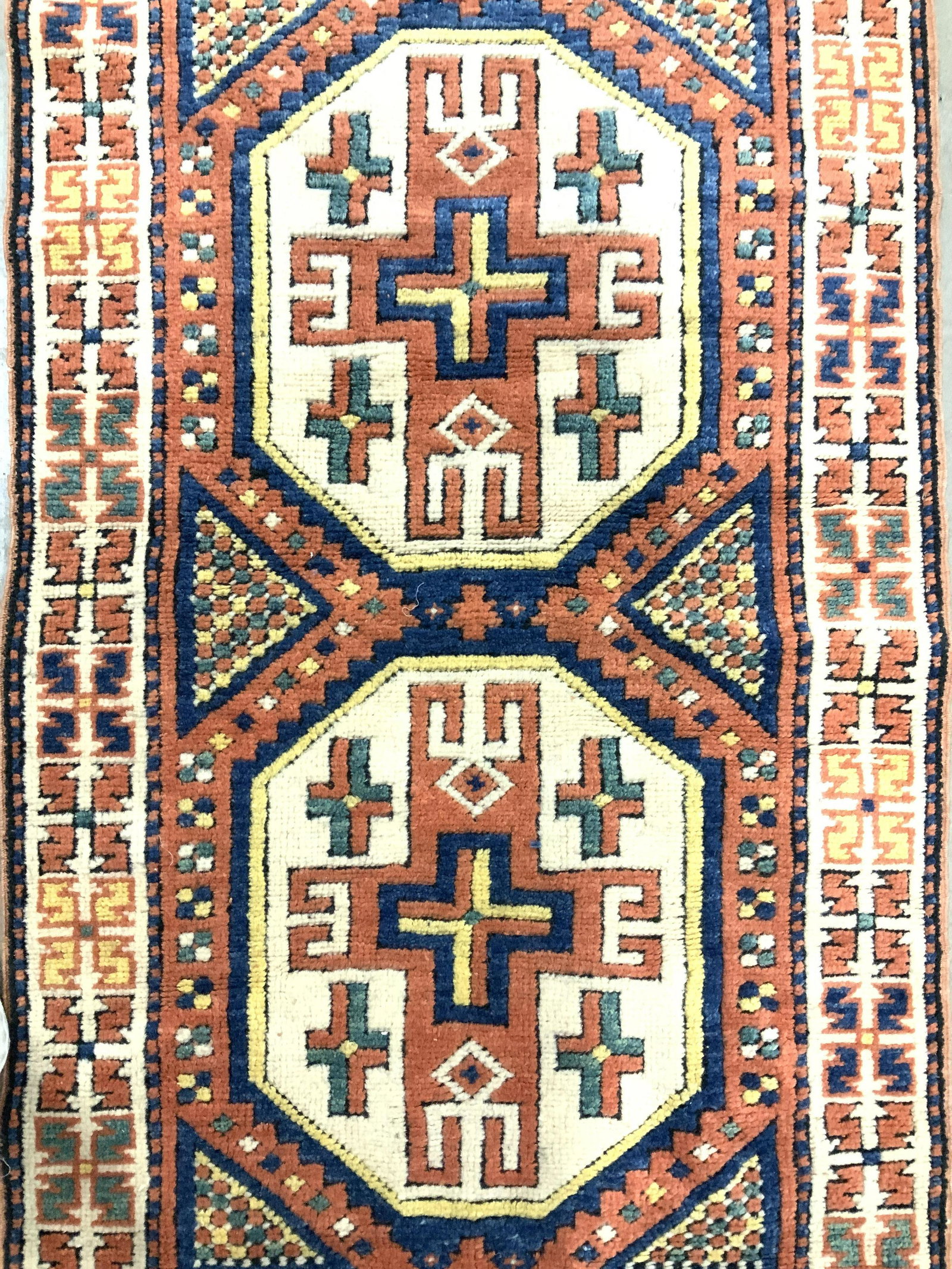 Vintage Handmade Turkish Wool Rug: Rug is wool and handmade. Piece is vintage possibly antique. Rug has intricate multi toned geometric detail with tones of blue, teal, cream, orange, black & yellow. Rug measures approximately 55 inche