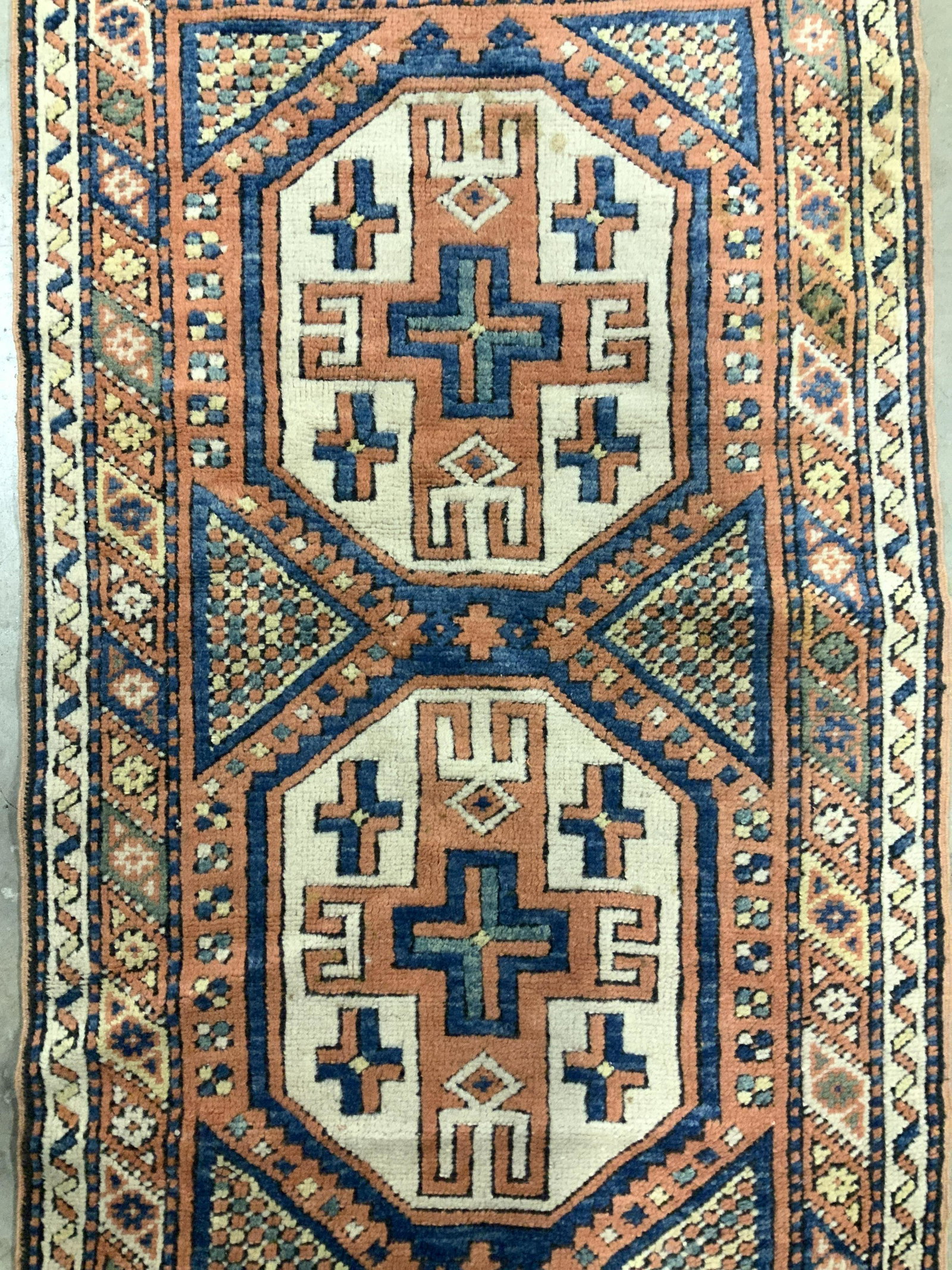 Vintage Handmade Turkish Wool Rug: Rug is wool and handmade. Piece is vintage possibly antique. Rug has intricate multi toned geometric detail with tones of blue, teal, cream, orange, black & yellow. Rug measures approximately 55 inche