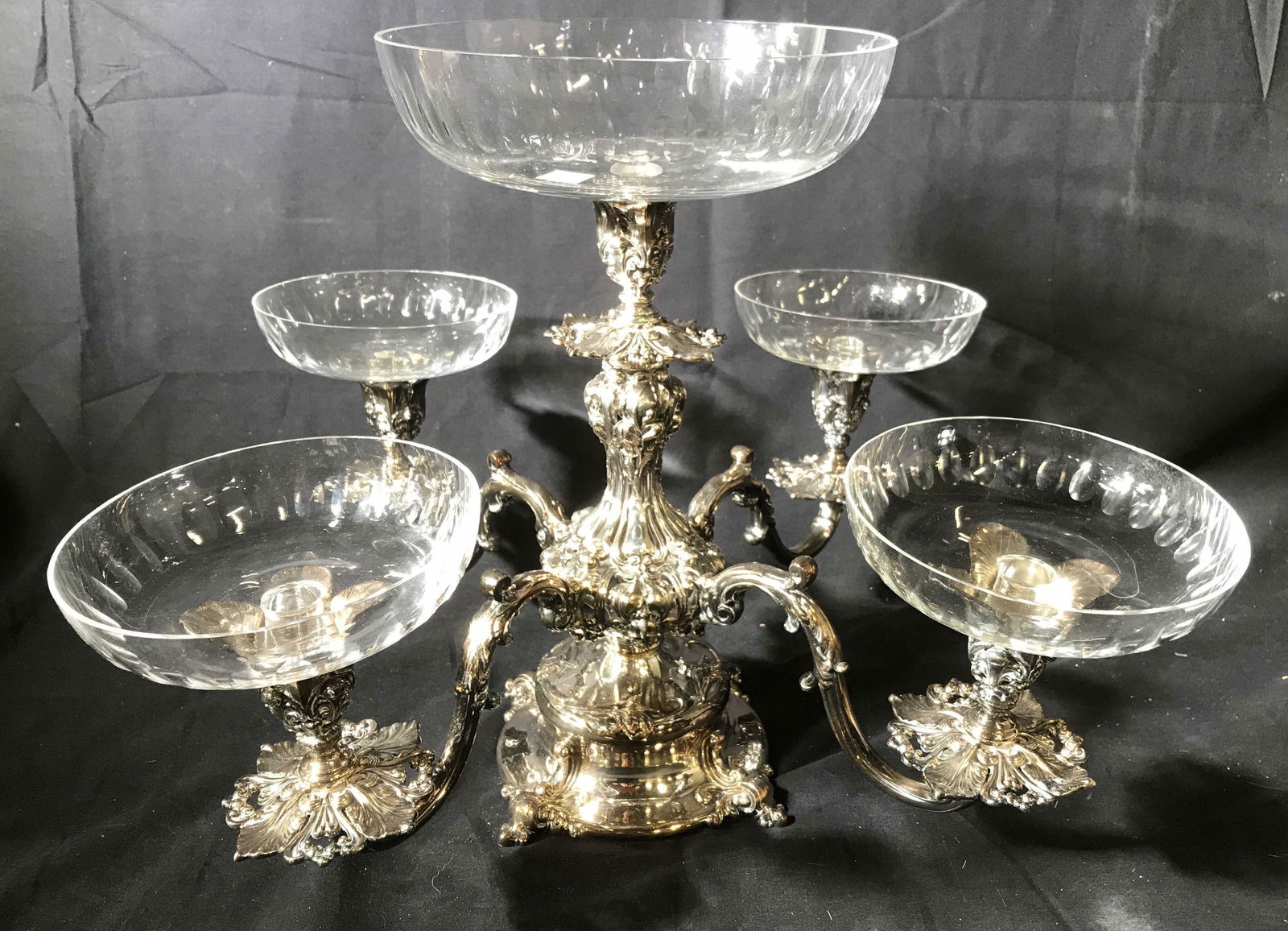 Reed and Barton Silver Plate Grand Epergne: Centerpiece , with five arms of intricate scrollwork and four crystal bowls with stems that fit into slots, one bowl included but broken, when bowls removed then transforms to grand candelabra, multip