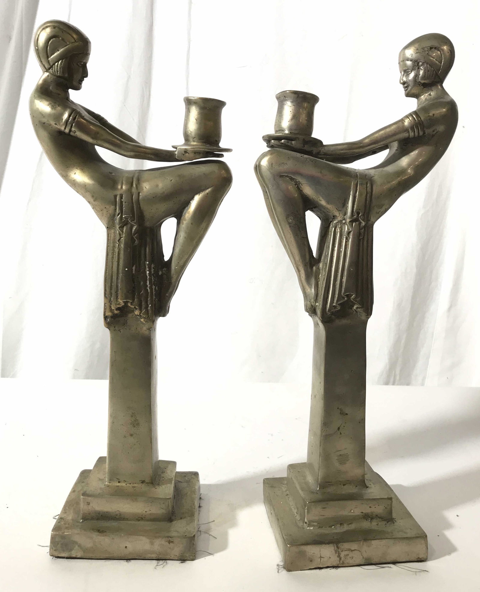 Pair Art Nouveau Metal Figural Candle Sticks: Art nouveau Figurals seated atop columns and holding candle stick holders in their laps, each measures app 16 inches ht , base 4.5 inches square, art nouveau tableware, decorative arts,