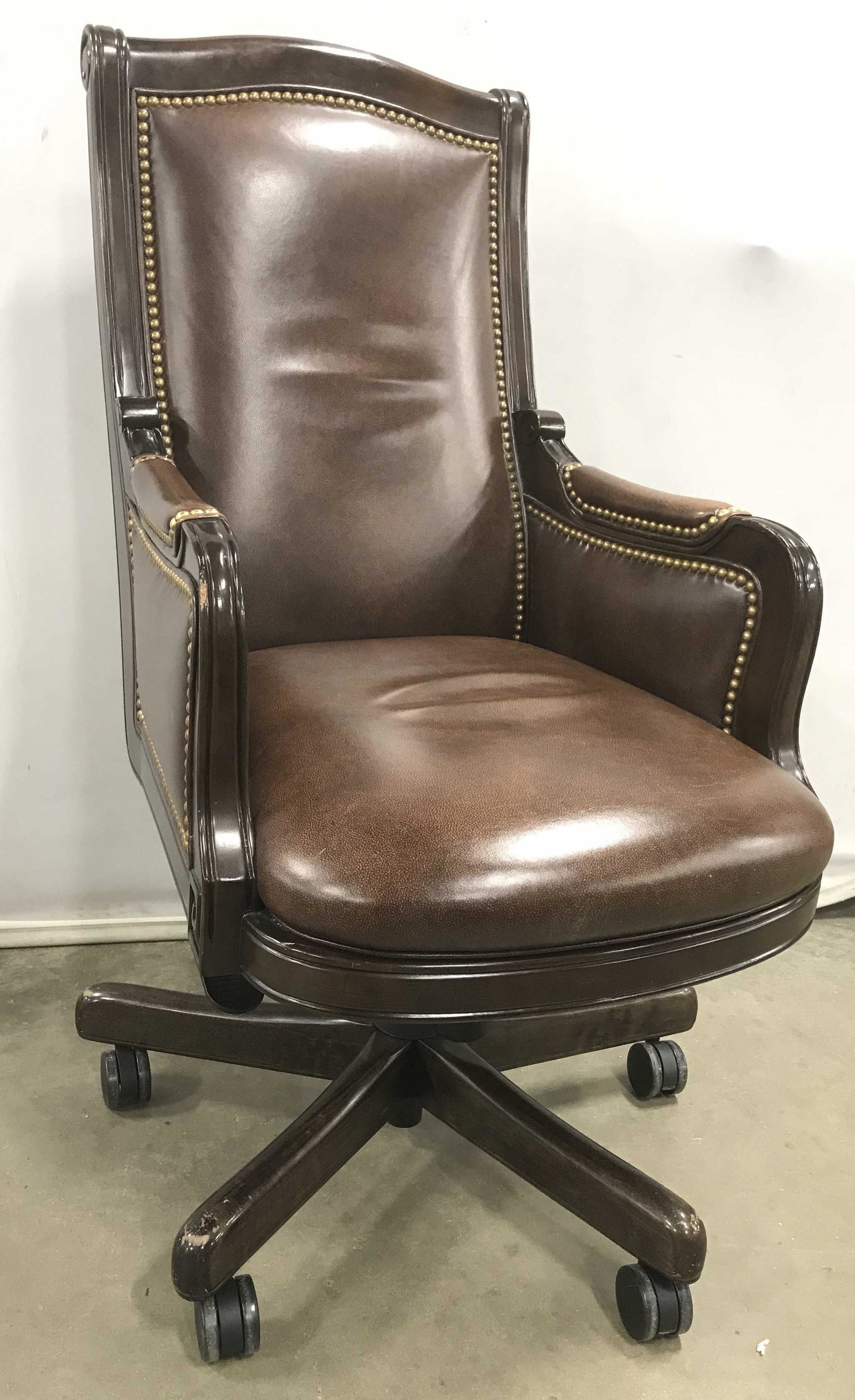 Hancock and More Swivel Leather Chair: Handsome desk chair genuine leather, wood frame, brass nail head trim, adjustable heights, label underside for leather and for Hancock and Moore, good condition, very slight scratches to lower wood an