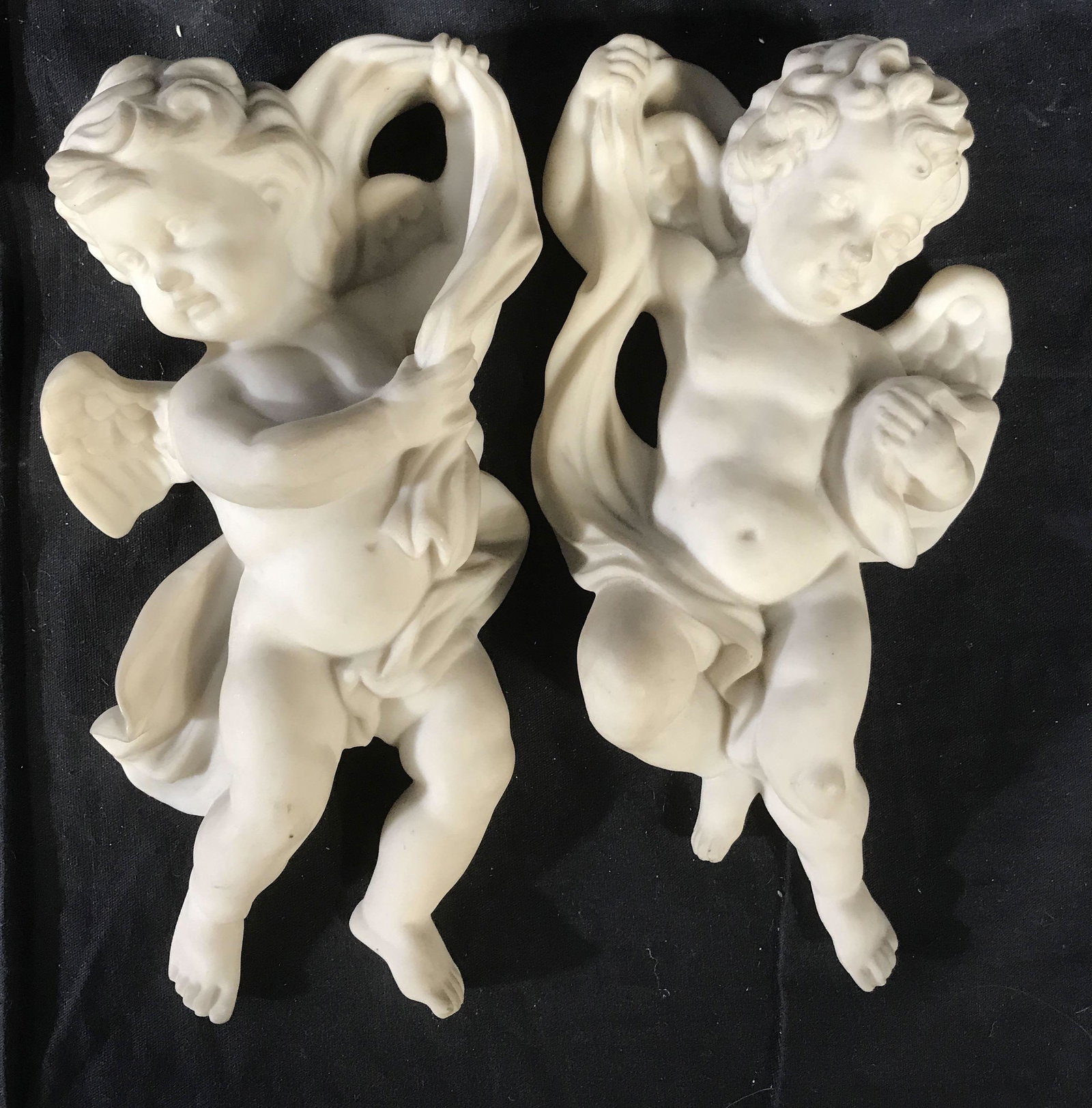 Pair Alabaster Composite Cherub Sculpture: Vintage cherubs, putt is, child angels, Cupid’s, appears to be alabaster, label on verso, each measures 10 inches ht 5,5 inches width, 3 inches depth, wall decor