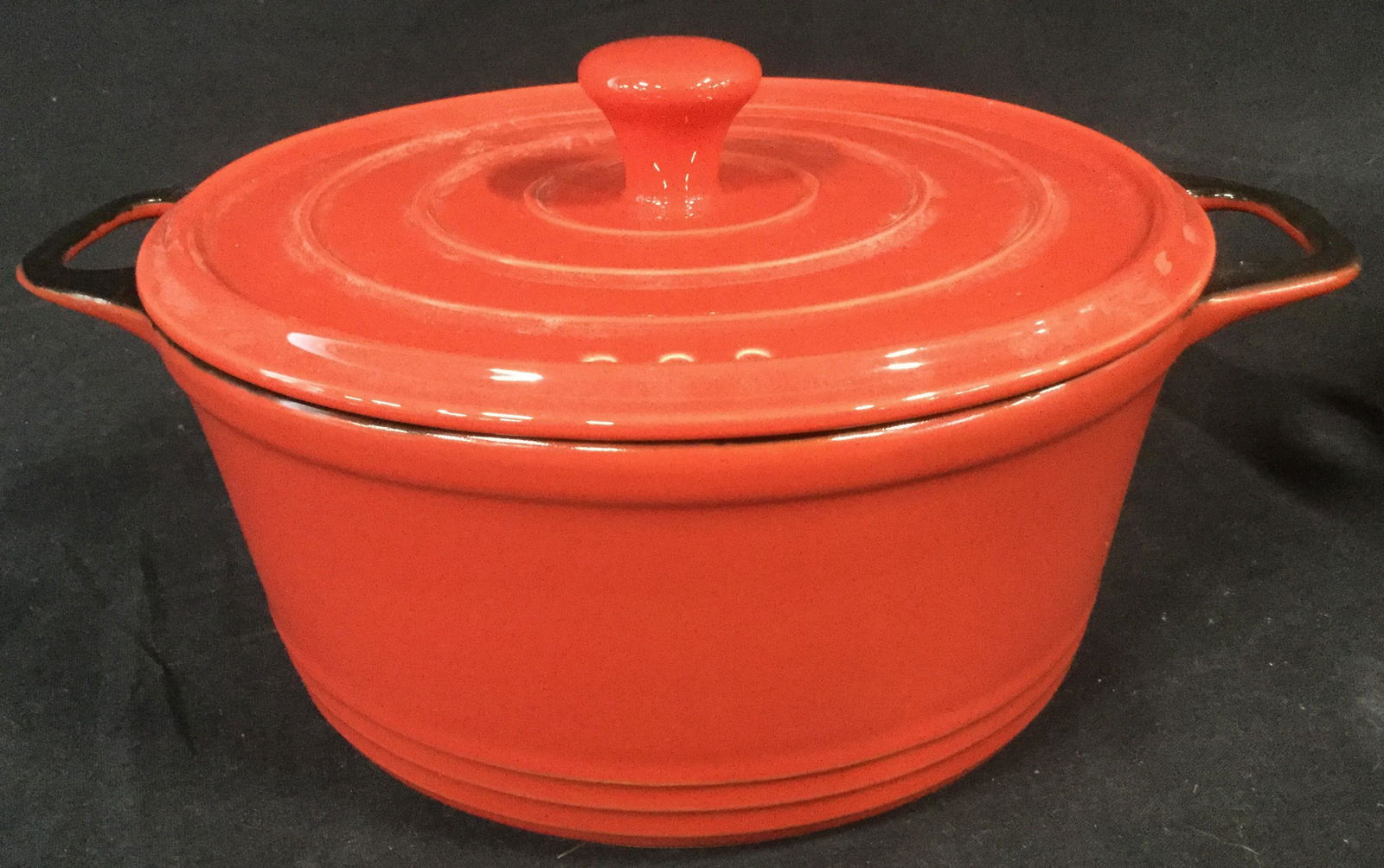 Set of Two PYREX Painted Retro Baking Pots: Set of two red and black ceramic baking pots with steam vents. Both pots feature handles on both sides for easy pickup. The smaller of the two is red on the outside and pot top, with a black interior.