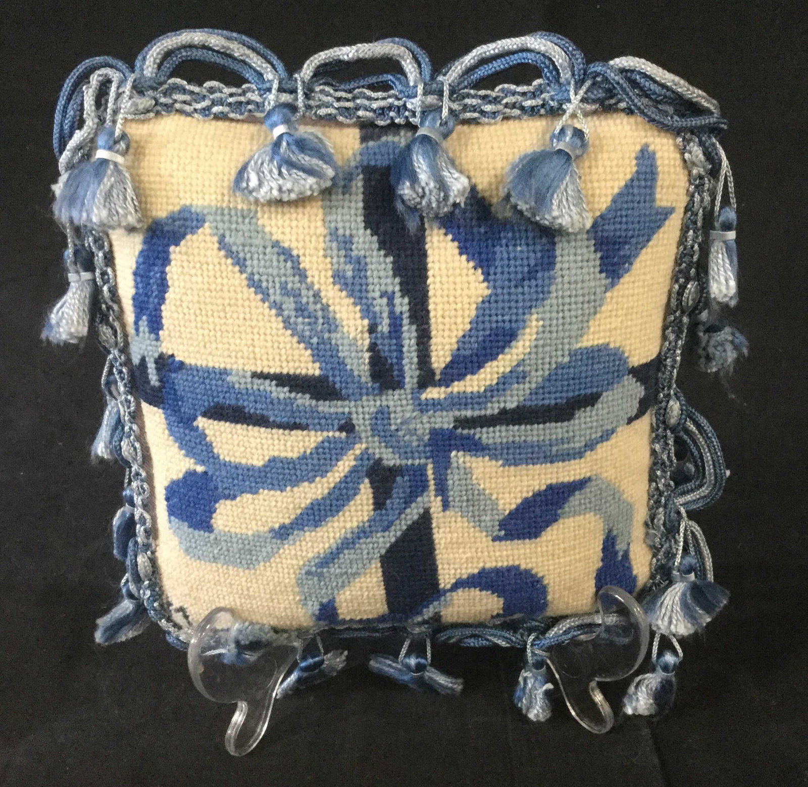 2 Small Wool Needlepoint Pillows: 2 small decorative hand Needlepoint pillows. First indoor home decor pillow features blue and white color pallet depicting a bow being tied around a present. Additionally, there is tassel trip around 