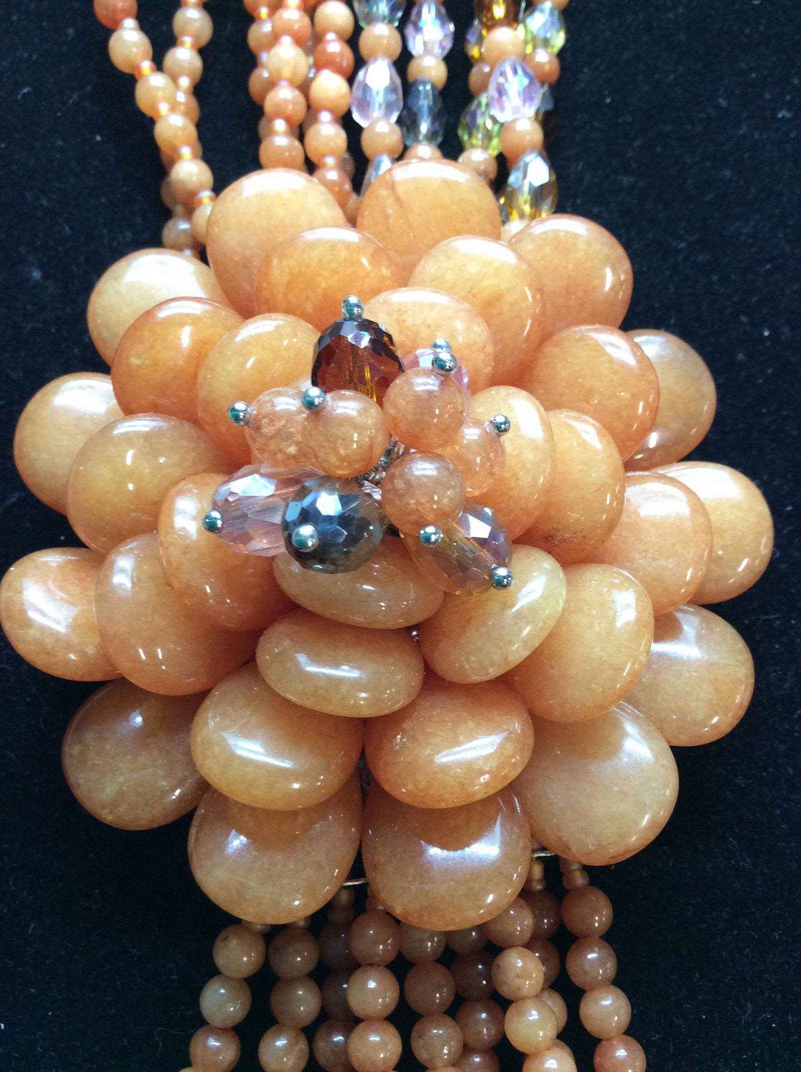 Elaborate Multi Strand Chalcedony Necklace: Collar size necklace with oversized Center Flower Pendant & cascading Beaded Tassels. Combination of aurora Borealis beads and Carnelian ( a natural quartz stone). Stones that make up flower measure 1