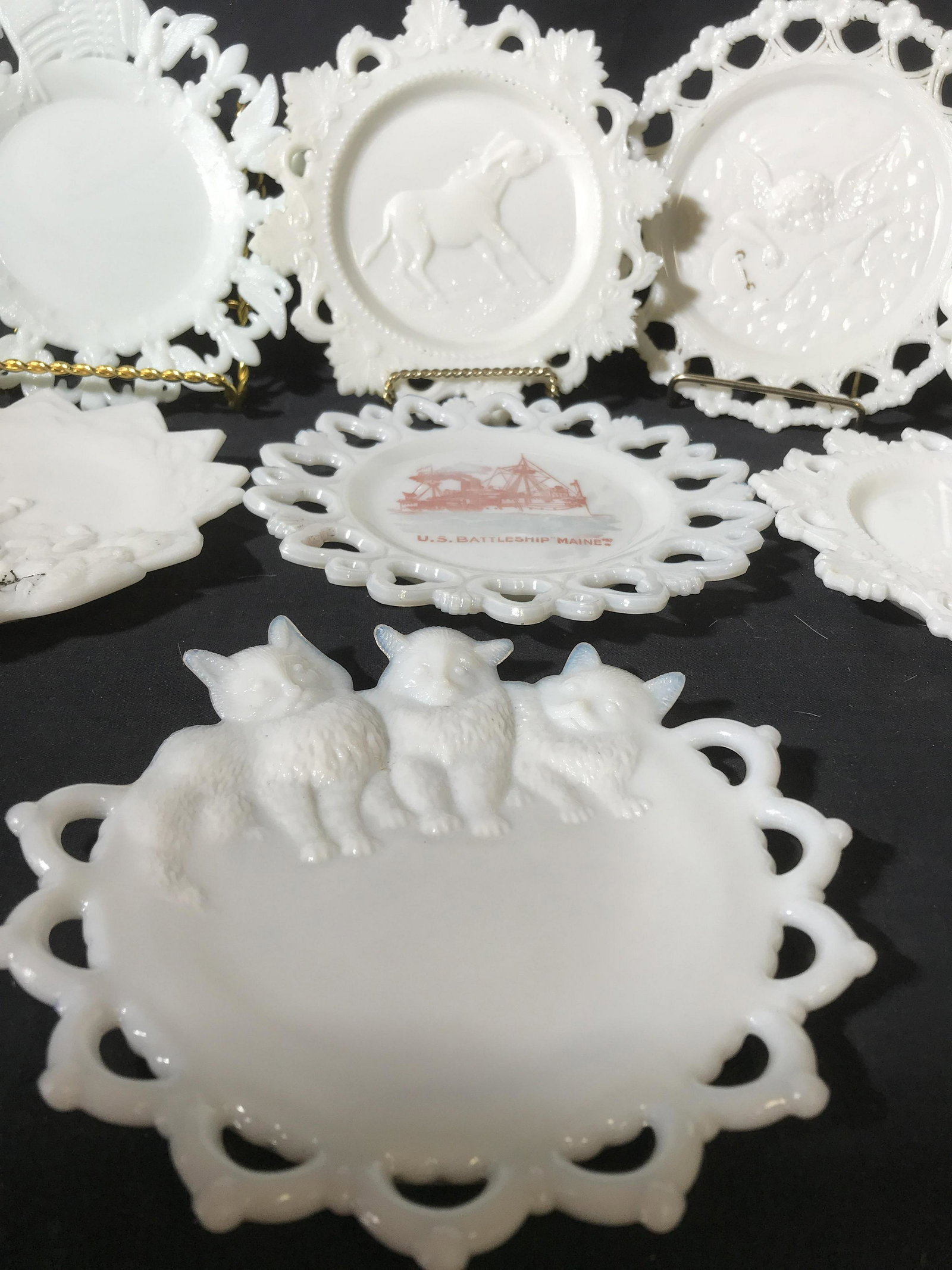 Group lot 8 Collectible Milk Glass Plates: Vintage antique, raised designs of cats, kittens, bears, wolves, garden scene, flags, eagles, flour de lids, horses, US batallian Maine, putti strumming guitar, and American Indian w full Headdress, m