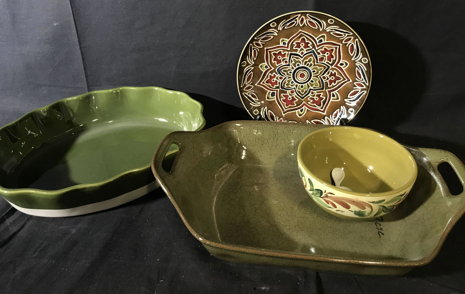 Green Glazed Ceramic Tableware Group: Lot includes platters, serving pieces, plate, bowl and spoons, handled serving dish measures length 16 inches, new old stock from Westchester ceramic store,one marked for Pier one. Tableware, tabletop