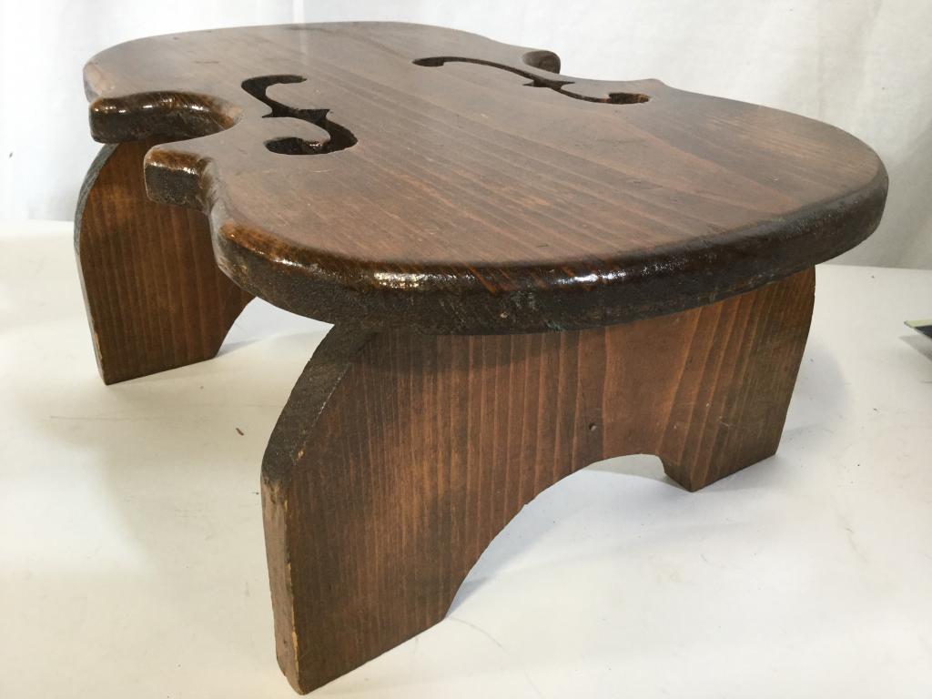Vintage Carved Wooden Violin Style Footstool: Footstool is wooden. Piece appears to possibly be hand carved. Piece measures approx 16 inches long 11 inches wide 7 inches tall. Stool ha been carved to resemble violin. Foot stool, carved wooden foo