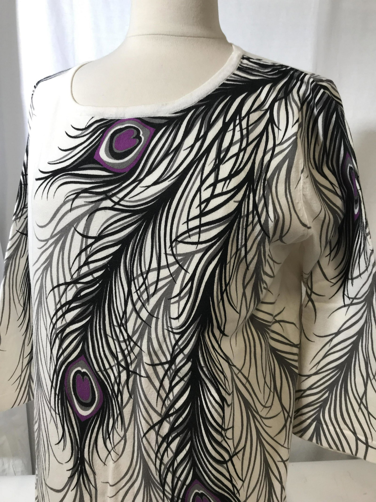 3/4 sleeve Peacock Feather Sweater, Med/Lrg: White cotton sweater, 3/4 sleeves, size Med, roomy enough to fit a large.has stretch. Black & grey & purple peacock print design. No designer label, has been cut out. Fashion Designer,Springtime Sweat