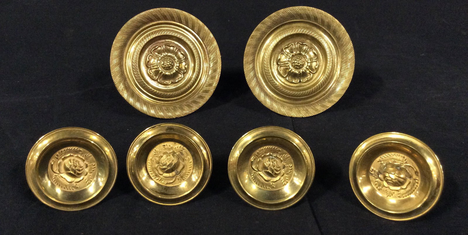 6 Vintage Brass Knobs And Cupboard Pulls: 6 Vintage possibly Antique Brass Knobs And Cupboard Pulls with raised rosette center design, large pull measures approximately 3.5 inches in diameter, smaller pull measures approximately 2 inches in d