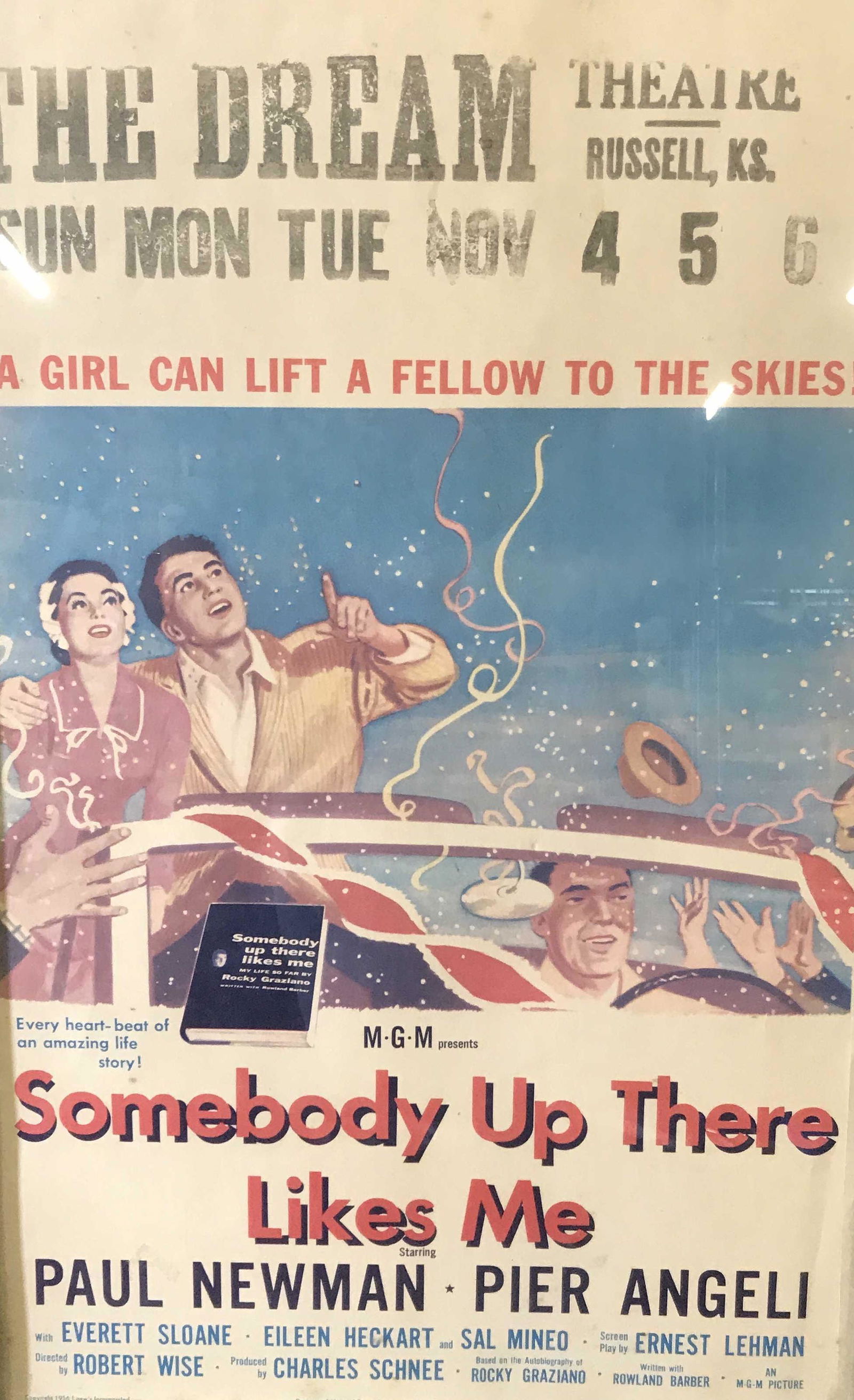 Vintage SOMEBODY UP THERE LIKES ME Movie Poster: this is a vintage movie theater poster for the DREAM THEATER IN RUSSEL, KANSAS. The plate is for the film SOMEBODY UP THERE LIKES ME, starring Paul Newman and Pier Angeli. The piece is set beneath gla