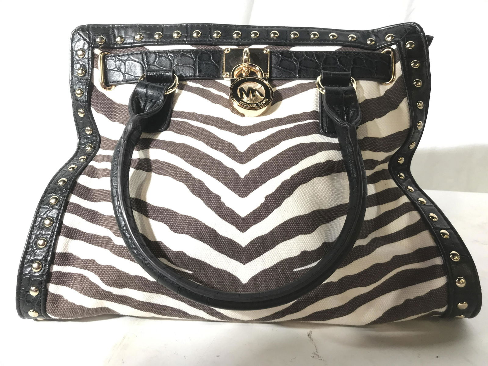 Michael Kor’s Canvas Leather Pocketbook: With gold toned metal hardware, zebra patterned canvas, studded leather trim measures app 13 inches ht by width 15 inches, property of New York City Estate fashion accessory, purse carry all, handbag,