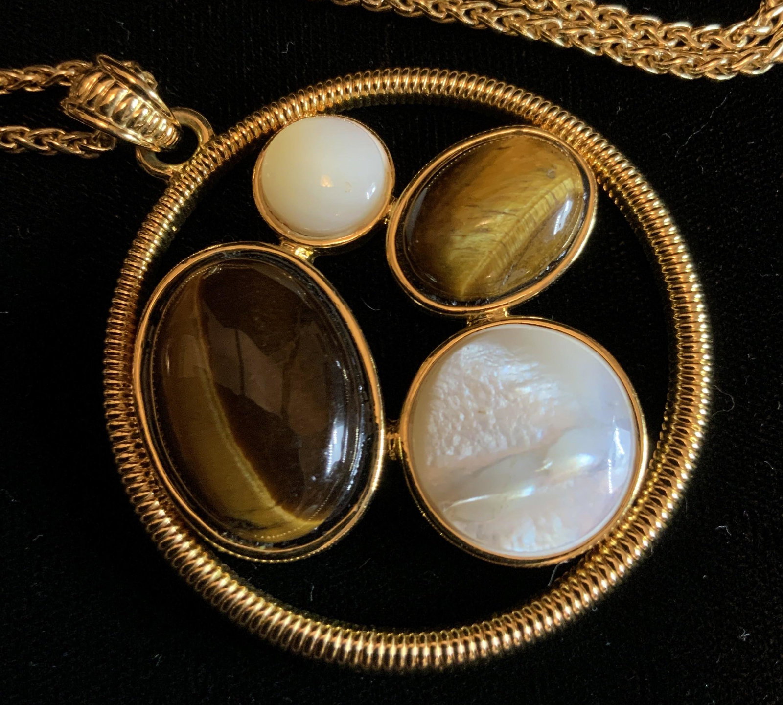 KJL Chain and Joan Rivers Fashion Pendant: Circular gold tone pendant encasing four synthetic pearl tigers eye cabochons, pendant marked for Joan Rivers, gold toned chain marked for KJL, Kenneth Lane, pendant diameter 2 inches chain length 19 