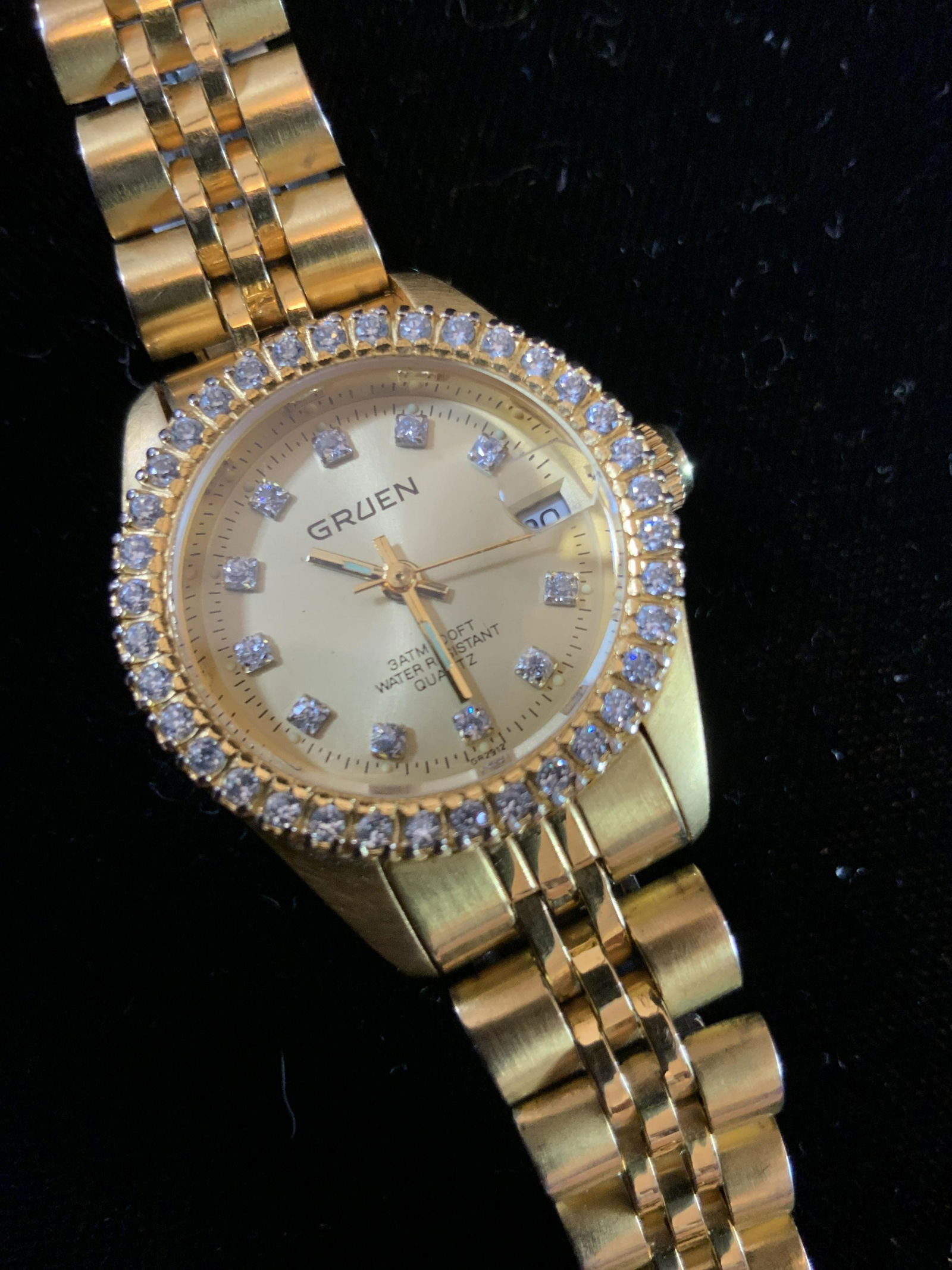 GRUEN Swiss Gold Toned Watch: With faux diamond bezel and Rolex Style Gold toned band, with deployment buckle, water resistant, Swiss watch, estate jewelry, Gruen Watch, measures diameter of face app 1 inches, estate jewelry, vint