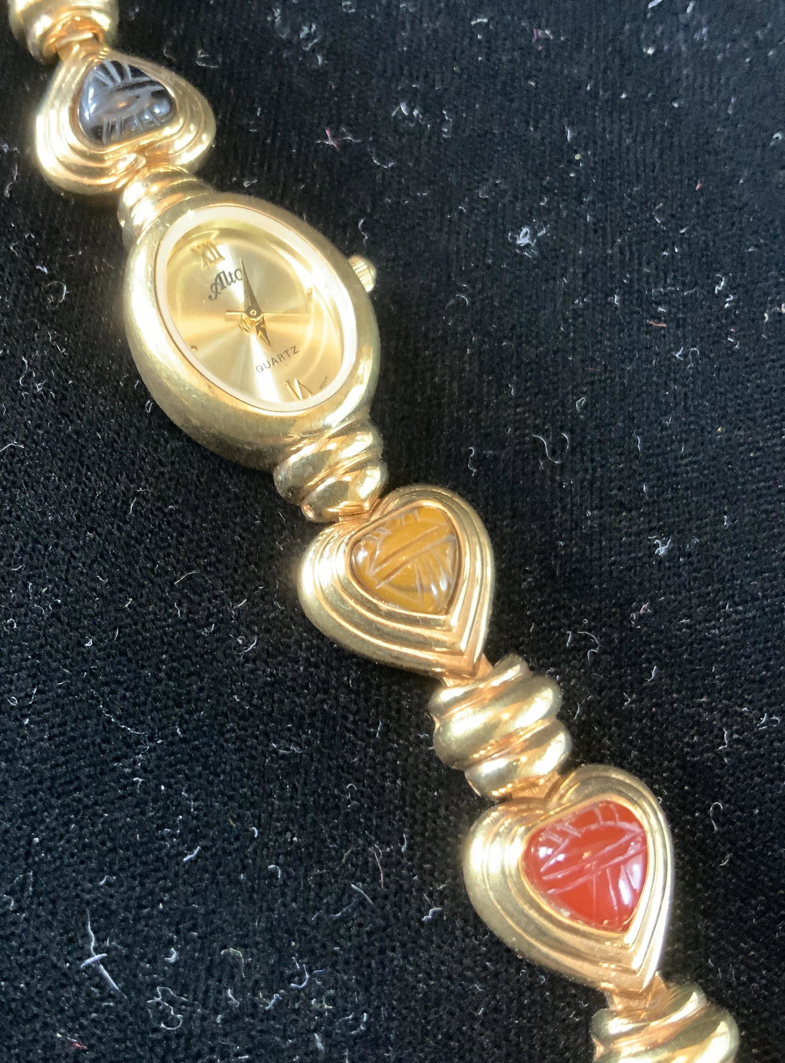 Alto Gold Tone Stone Bracelet Watch: Link watch with gold toned encased semi precious stones with etched design and center oval faced watch, fashion jewelry, estate jewelry measures open length app 7.5 inches