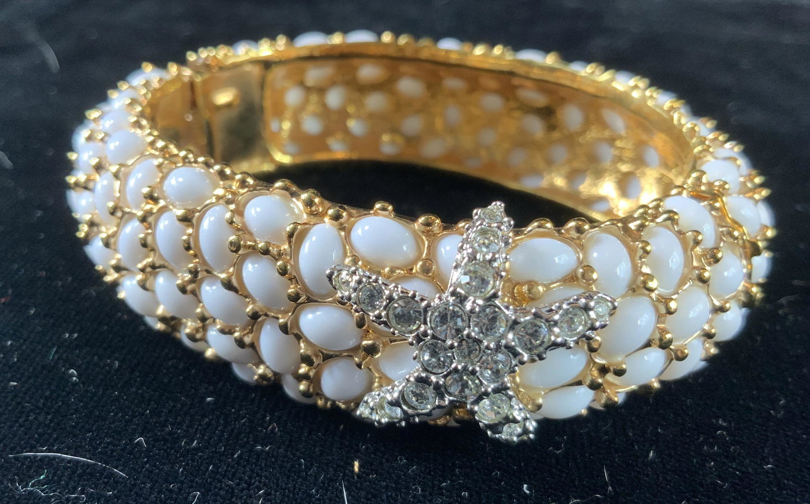 KJL Starfish And faux coral Stone Bracelet: Kenneth j Lane hinged gold toned bracelet with rhinestone starfish on textured bubbled white faux stone bracelet with gold toned latticed design, diameter app 3 inches, vintage jewelry, estate jewelry