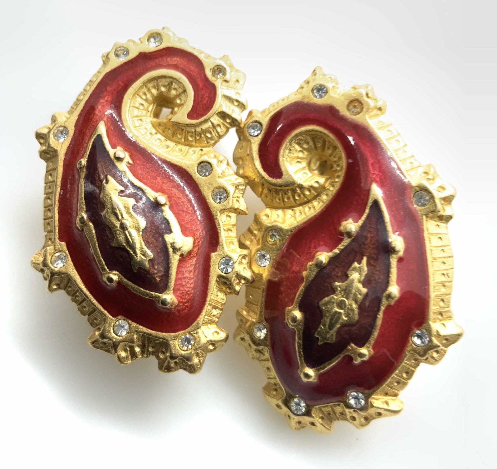 Pair Vintage Bob Mackie Clip on Earrings: Paisley design gold toned earrings with red and amber toned enamel accents, signed on back for Bob Mackie, each measures drop app 1.5/inches, estate jewelry, vintage jewelry, designer costume jewelry,