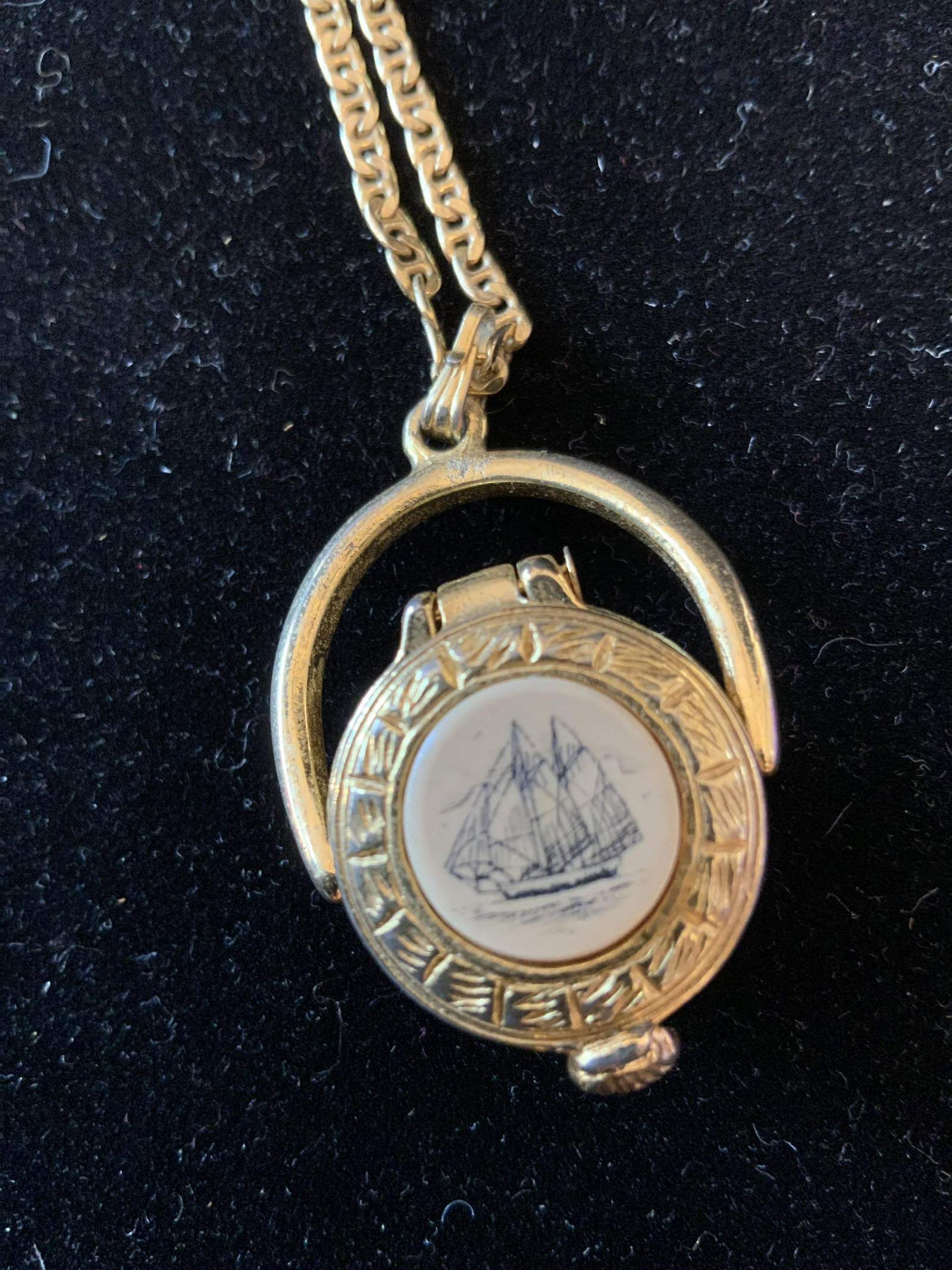 Gilded Pewter Nantucket Basket Form Necklace: Gilded pewter necklace, under lid of basket marked for pewter, chain necklace with Nantucket basket form pendant, top has scrimshaw style lid with sailing vessel, basket lid opens on hinge, pill conta