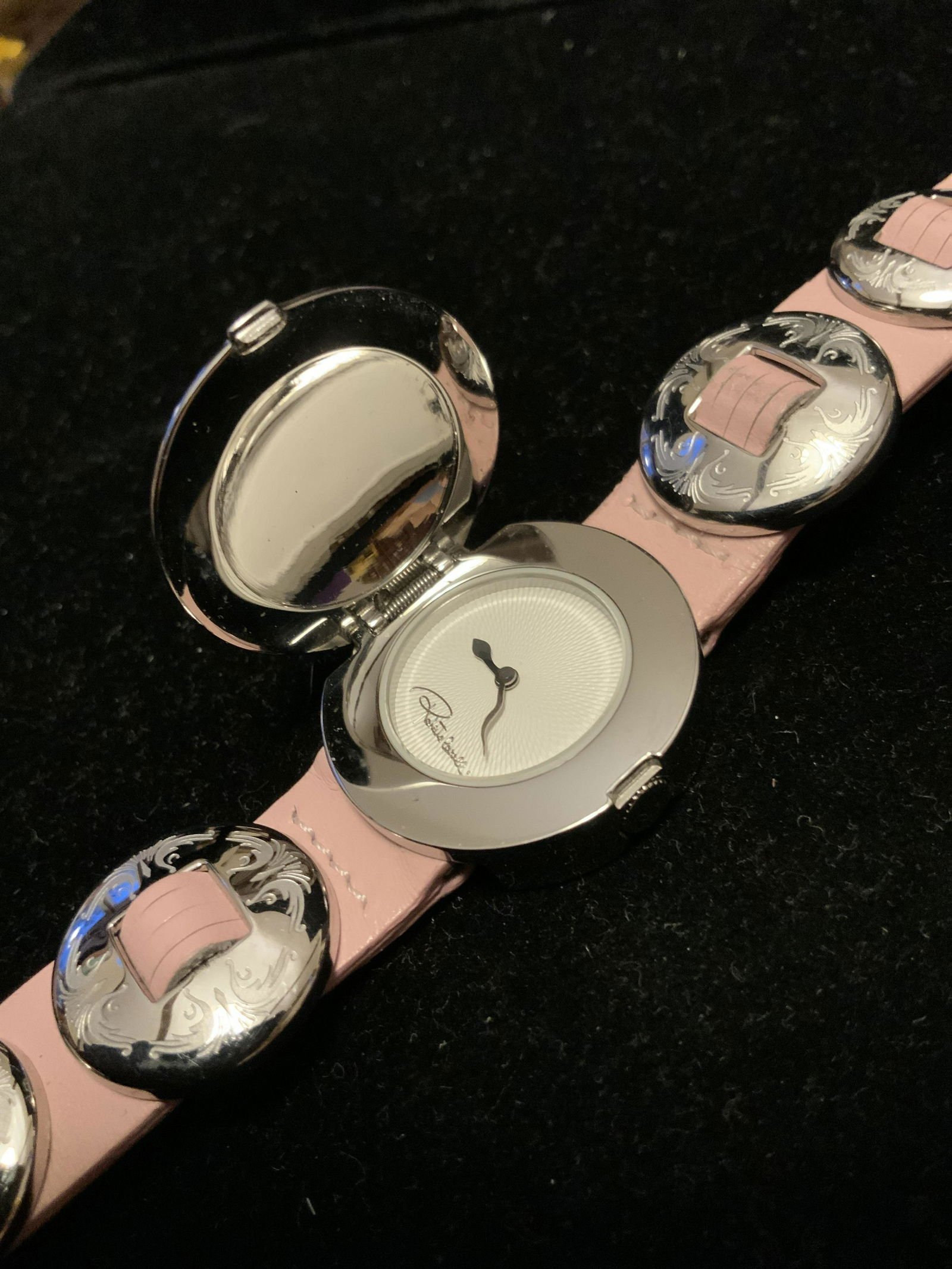 ROBERTO CAVALLI Designer Bracelet Watch: Made in Italy, ornate watch or bracelet, Italian luxury designer Roberto CAVALLI, luxury fashion accessory, pink leather band, embossed silver discs, Center is flip top watch, with silver centerpiece