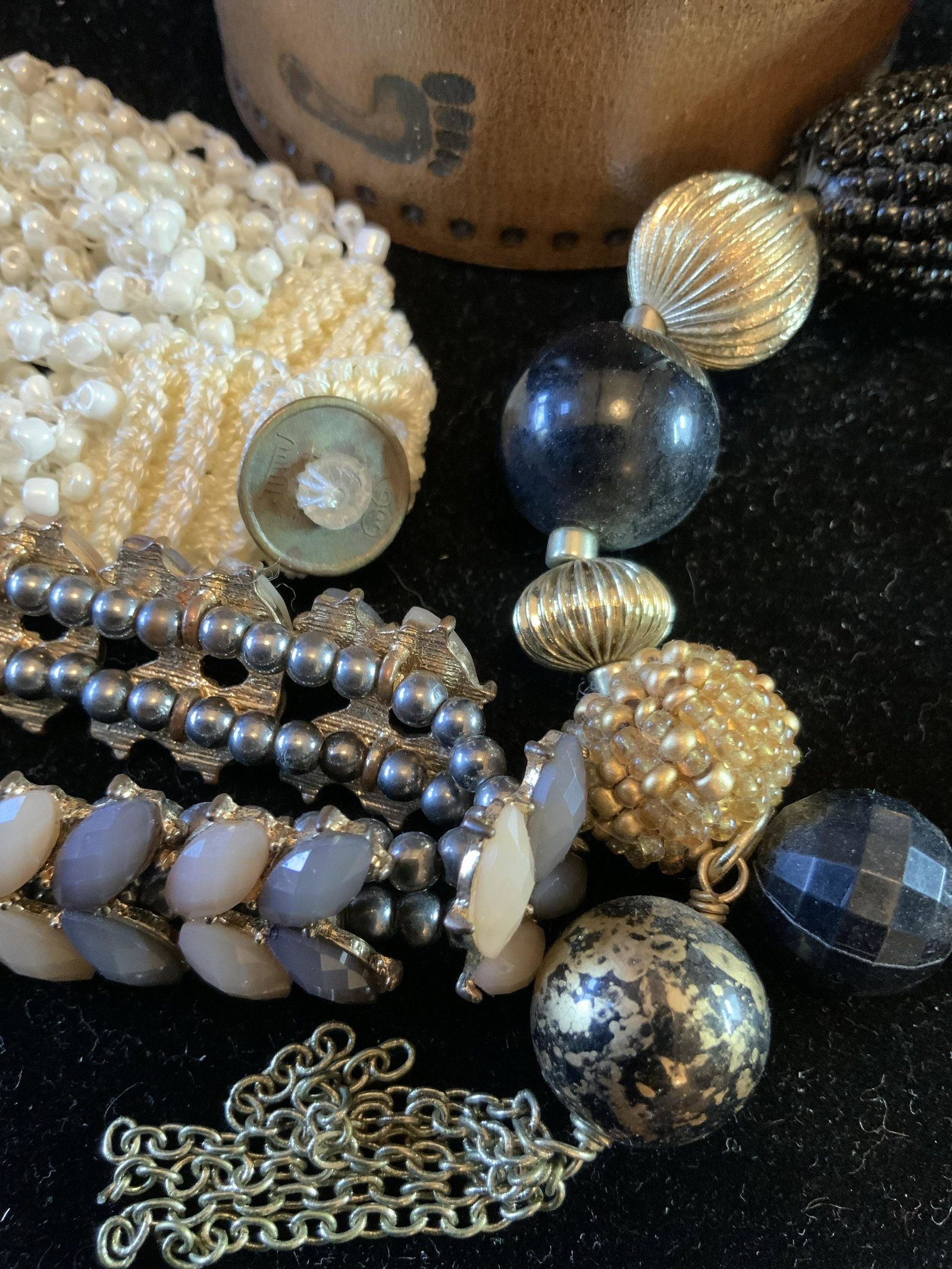 Group 5 Vintage fashion Bracelets: One tooled leather bracelet with foot prints width app 2 inches, one purple silk woven with silver center bead that Reads LINKS of LONDON, one pearl style beads, one multi textured beads w tassel, and