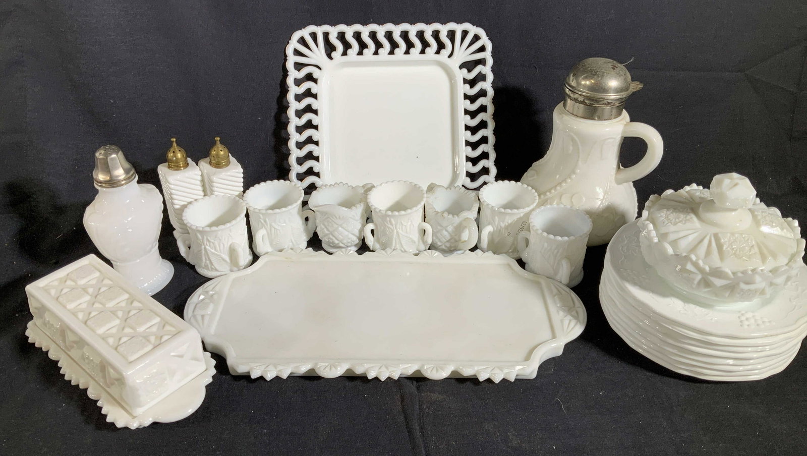 Group Lot Vintage Antique Milk Glass Tableware,: Metal hinges lidded syrup dispenser tallest ht app 8 inches, set of 8 saucers, oblong tray length 13 inches, salt pepper shakers, sugar dispenser, three handles mugs lattice rimmed plate, lidded butte