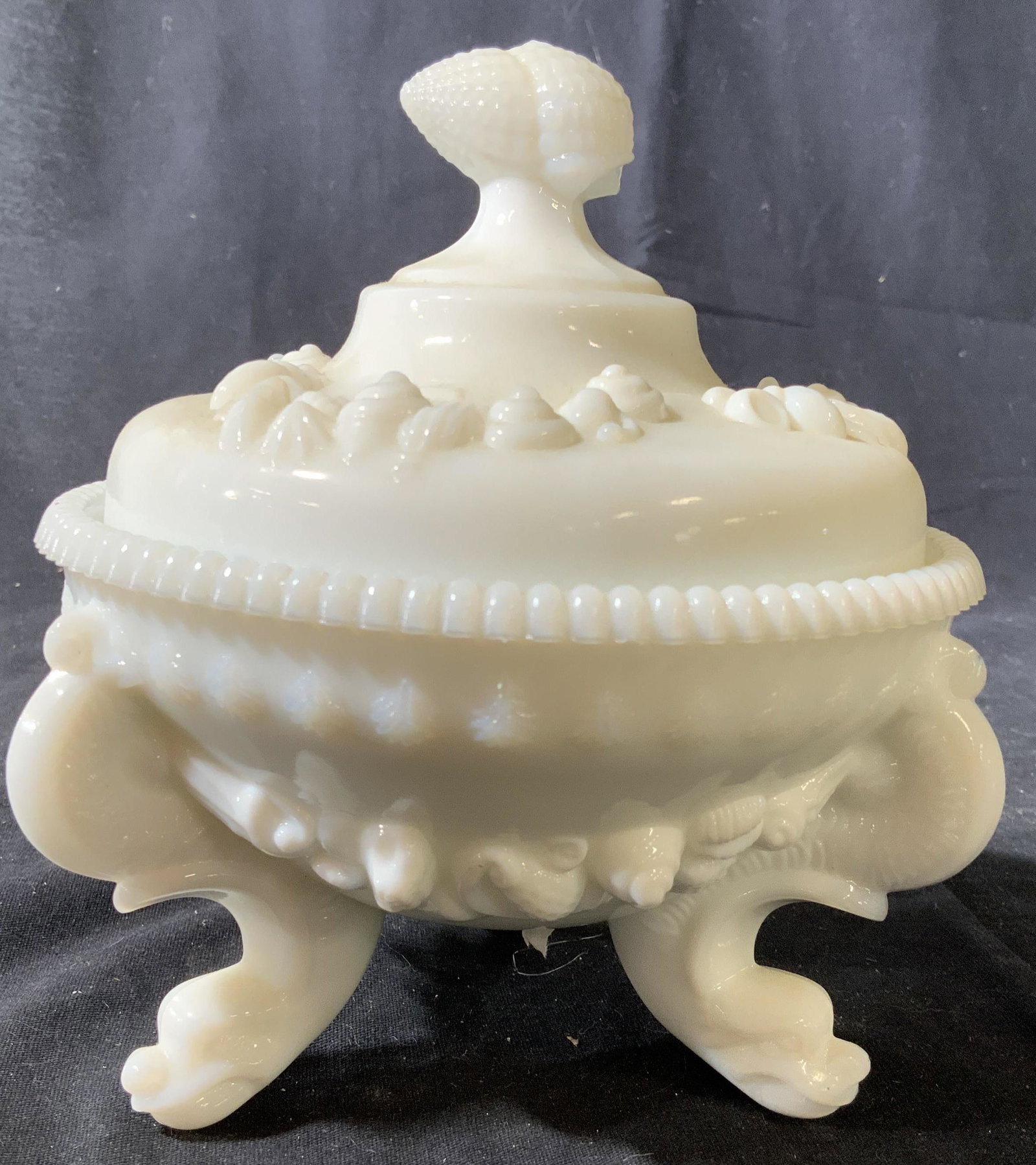 Lidded Sea Theme Compote Milk Glass: Adorned with sea shell Reliefs, three Porpoise Fish feet, lidded vessel, tableware, collectible milk glass measures ht 7 inches, diameter app 6.5 inches