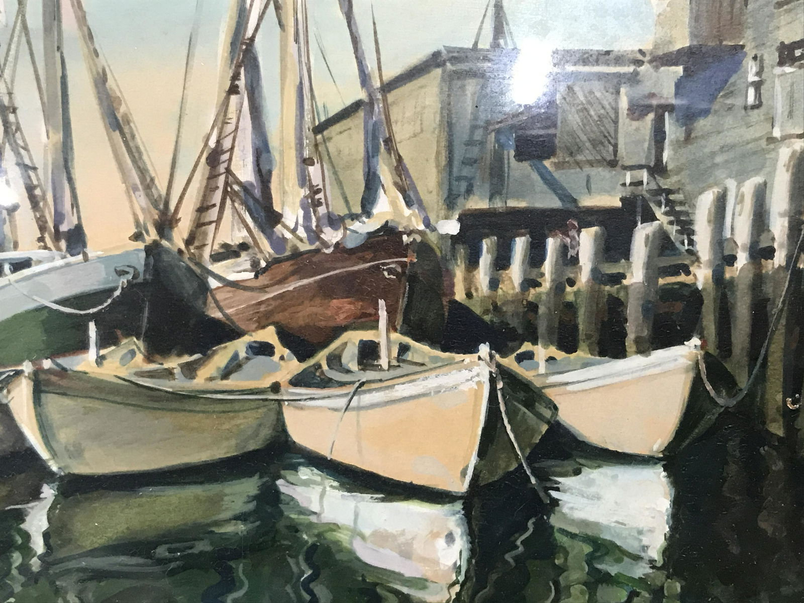 Pair of Watercolor Prints: Pair of watercolor prints of ships, one depicts a boat near land with a rowboat and marine house the other depicts multiple ships at dock, the first has an inner border of gold paint the second has on