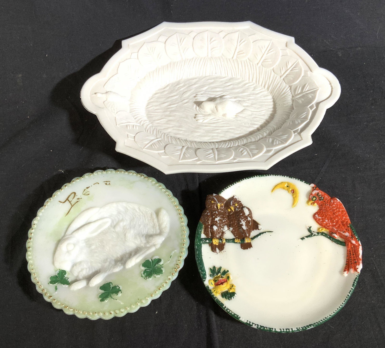 3 Antique Milk Glass Collectible Plates: Largest has center figural of fox measures length 13.5 inches by 10 inches one is green toned with sunken center rabbit figural, one has painted red bird owl Figurals and moon, whimsical collectible a