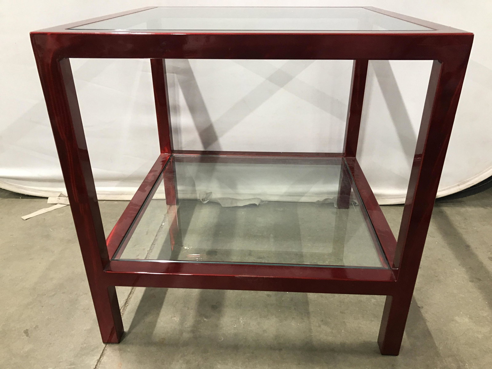 Industrial Modern Glass Top Side Table: Side table has glass top. Frame of table is red toned and metal. Table also has 1 tier underneath tabletop with glass. Table, side table, glass top table, glass top side table. end tbale, home furnish