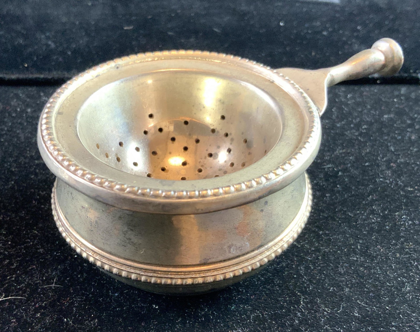 2 piece Silver Toned Tea Strainer Tableware: Two piece silver toned bowl with strainer insert, tea strainer, condiment bowl, tableware tabletop decor, measures diameter app 4.5 inches, ht 2 inches, collectible