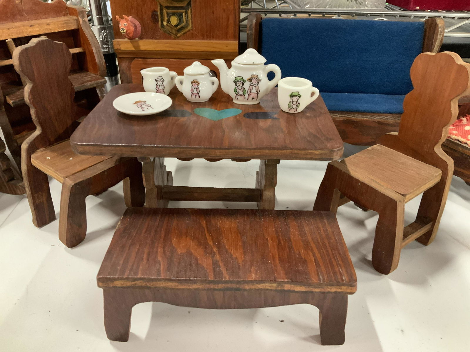 Group Lot Vintage Doll House Furniture: Miniature China tea set, porcelain place settings, hand made wood doll house furniture, tallest piece is wall with fireplace, wood animal head and clock decal, measures ht app 12.5 inches, metal bed,